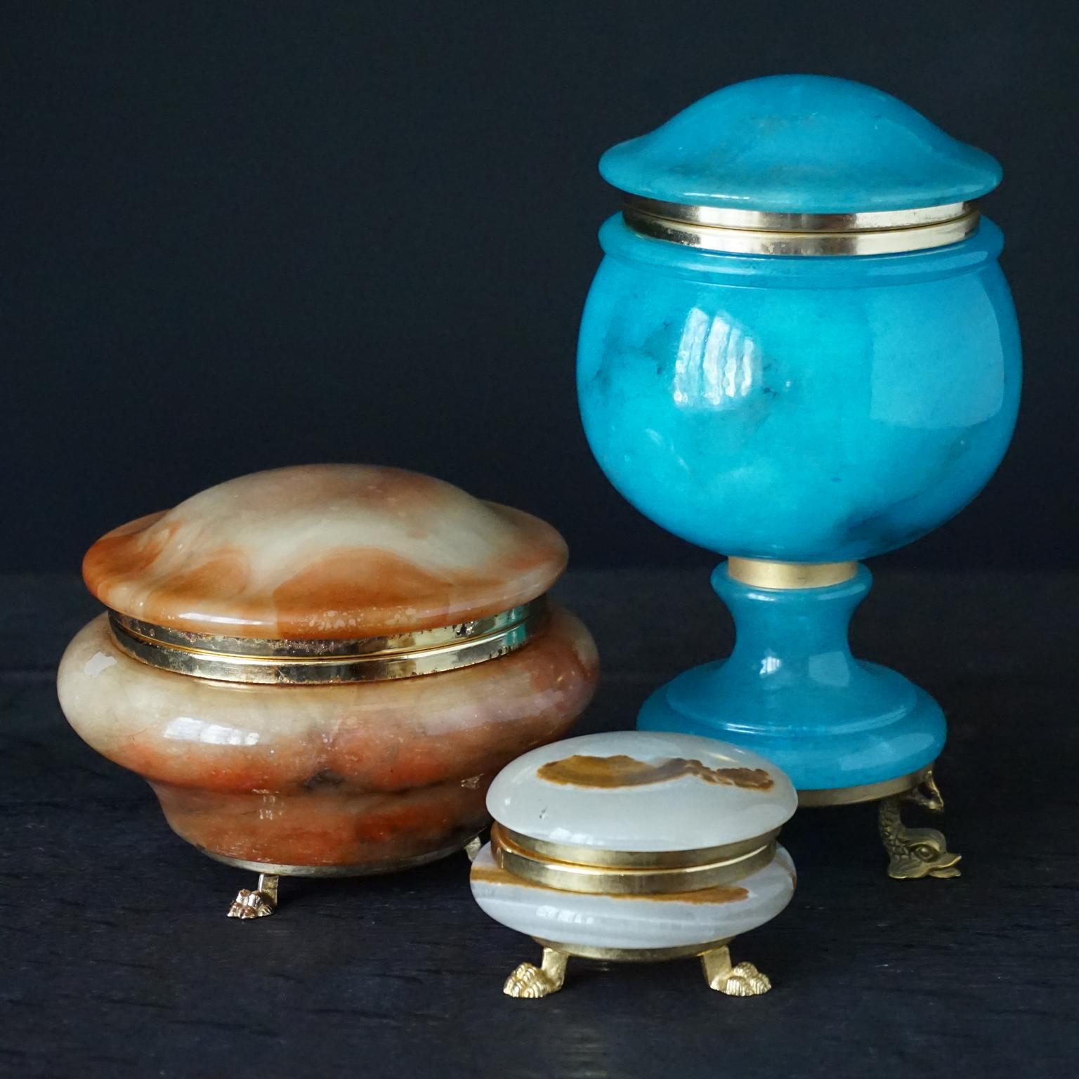 Set of three hand carved Italian alabaster claw and dolphin footed decorative boxes in blue, orange and beige coloured alabaster.
I fell in love with their beautiful shiny colours and the heaviness of the material of these jewellery boxes with