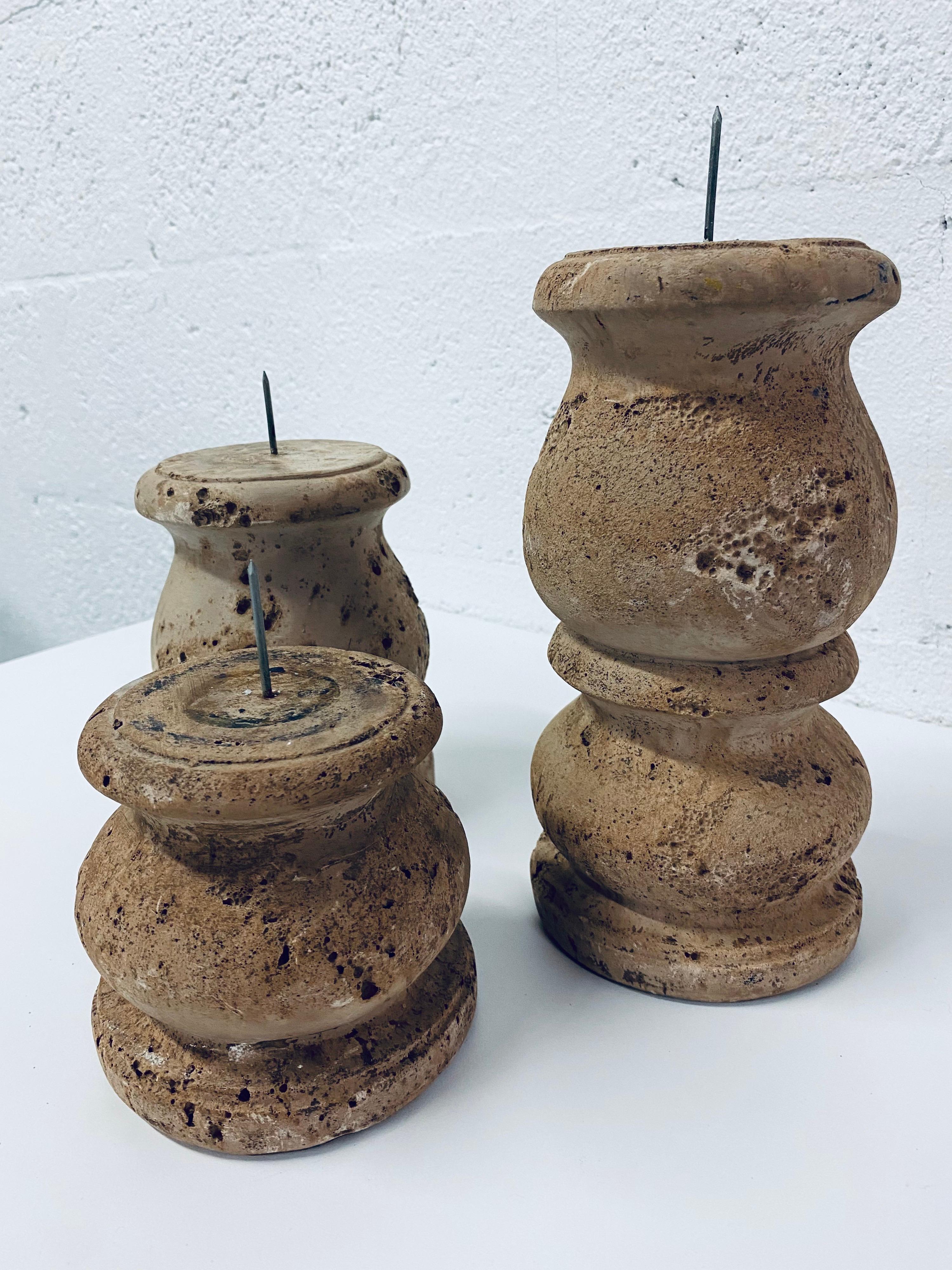 Set of three midcentury candlestick holders by Jaru made of brown/tan cast stone.

Measurements (does not include the 1-1/2