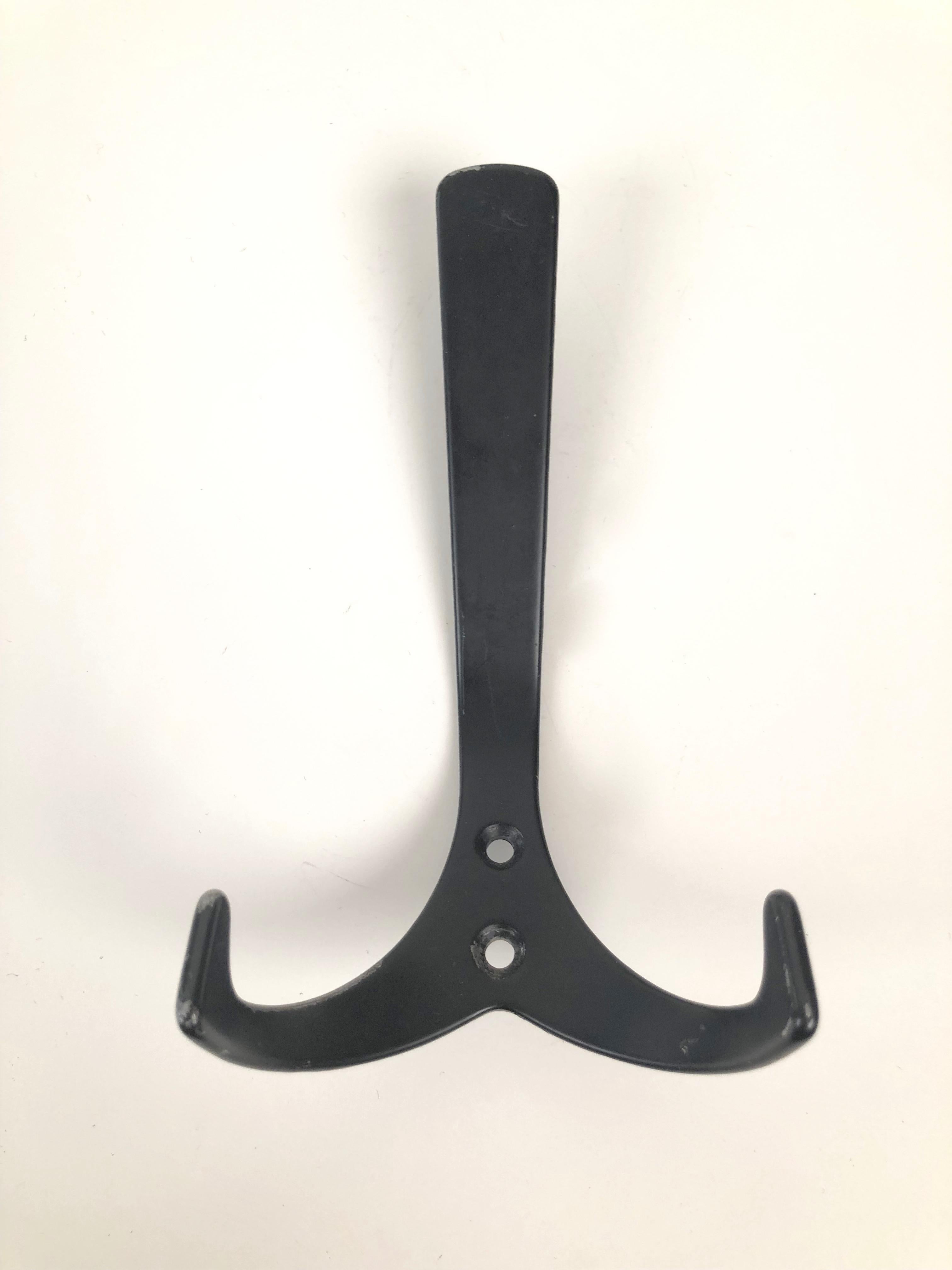 Three forged metal coat hooks from Austria. Made in the 1950s, they have coated in black color.