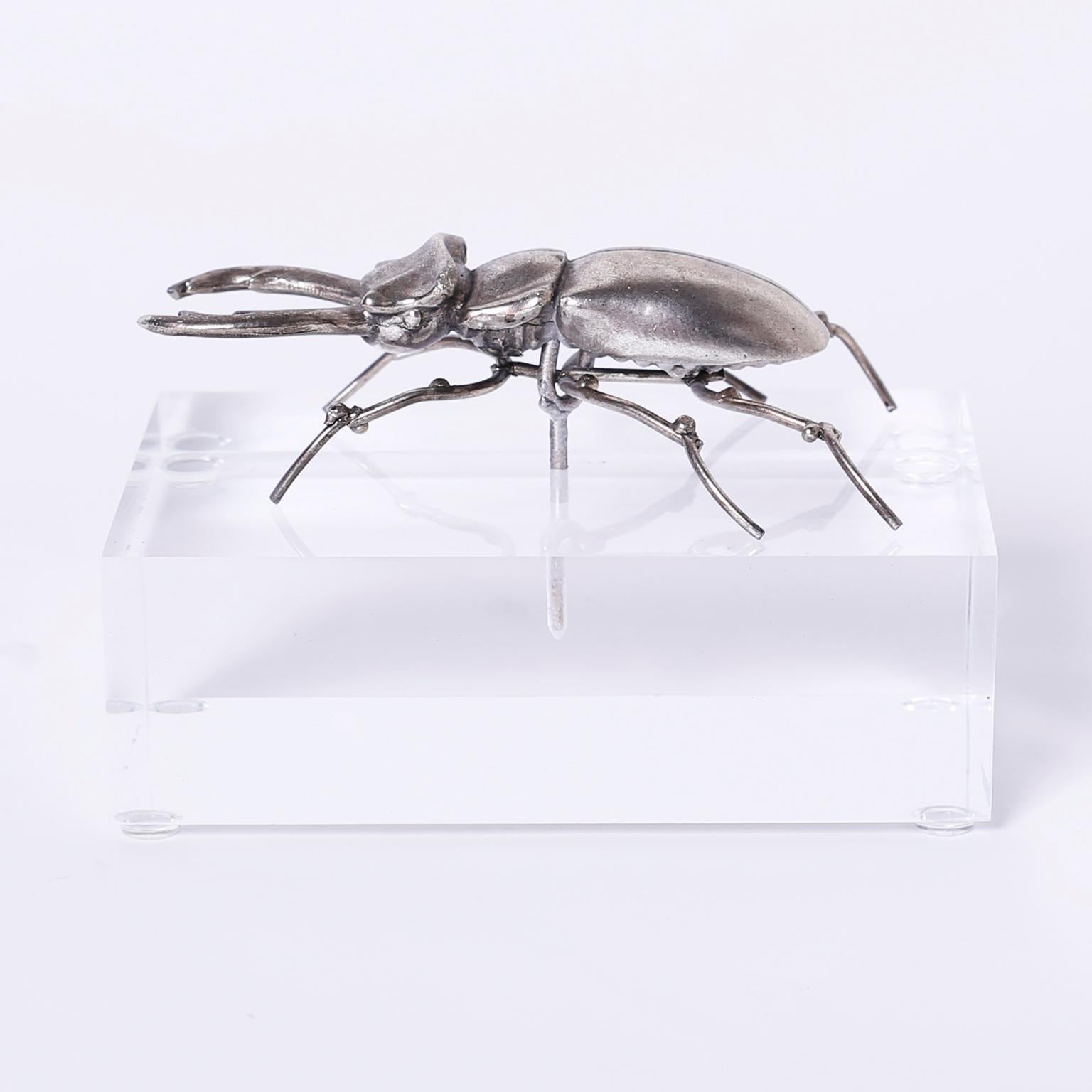 Two insect sculpture of a beetle and a grasshopper crafted in silver plate over brass with ambitious detail and presented on Lucite bases. Priced Individually.

Dimensions: 
Left: H 4, W 6, D 4 
center  SOLD 
right: H 5 W 8, D 4 
