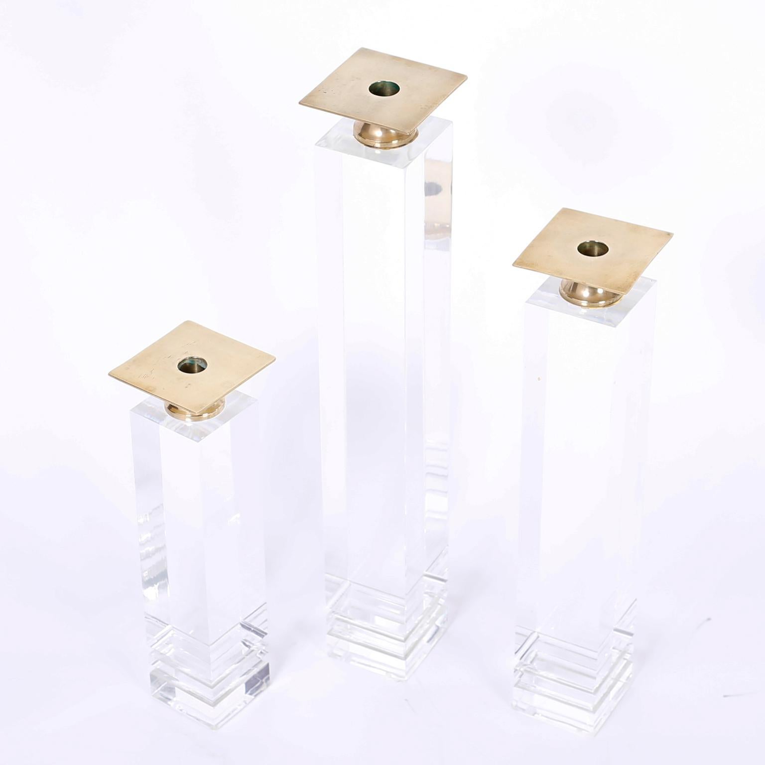 Set of three midcentury Lucite candlesticks with polished brass candle cups on acrylic bases with architectural appeal.
Measures: SM- H 13, W 3.5, D 3.5, MED- H 17, W 3.5, D 3.5, LG- H 21, W 3.5, D 3.5.