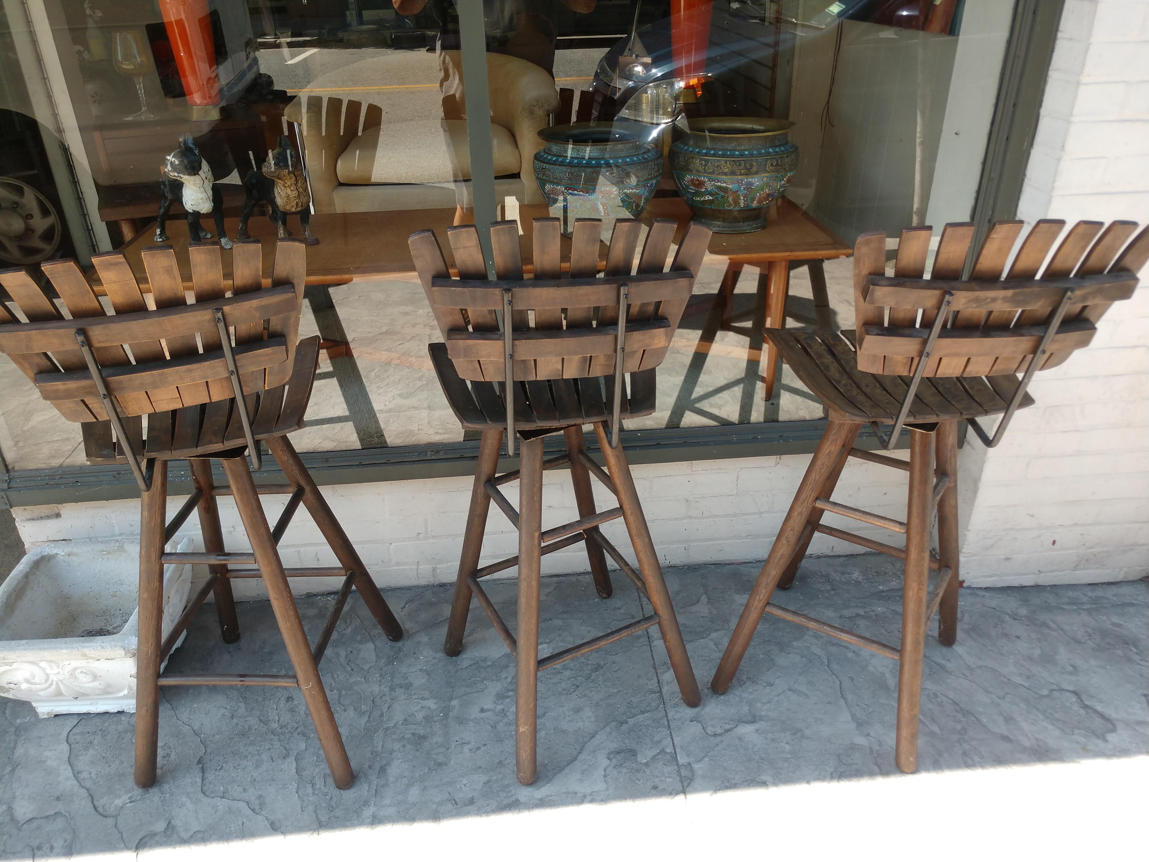 Fabulous wood slatted seats and backs which rotate to your desire. Iron supports brace the backs. Very tight and well maintained. Sold as a set of 3. We have a similar pair for sale in another listing. Along with ones with iron frames. Seat hgt is