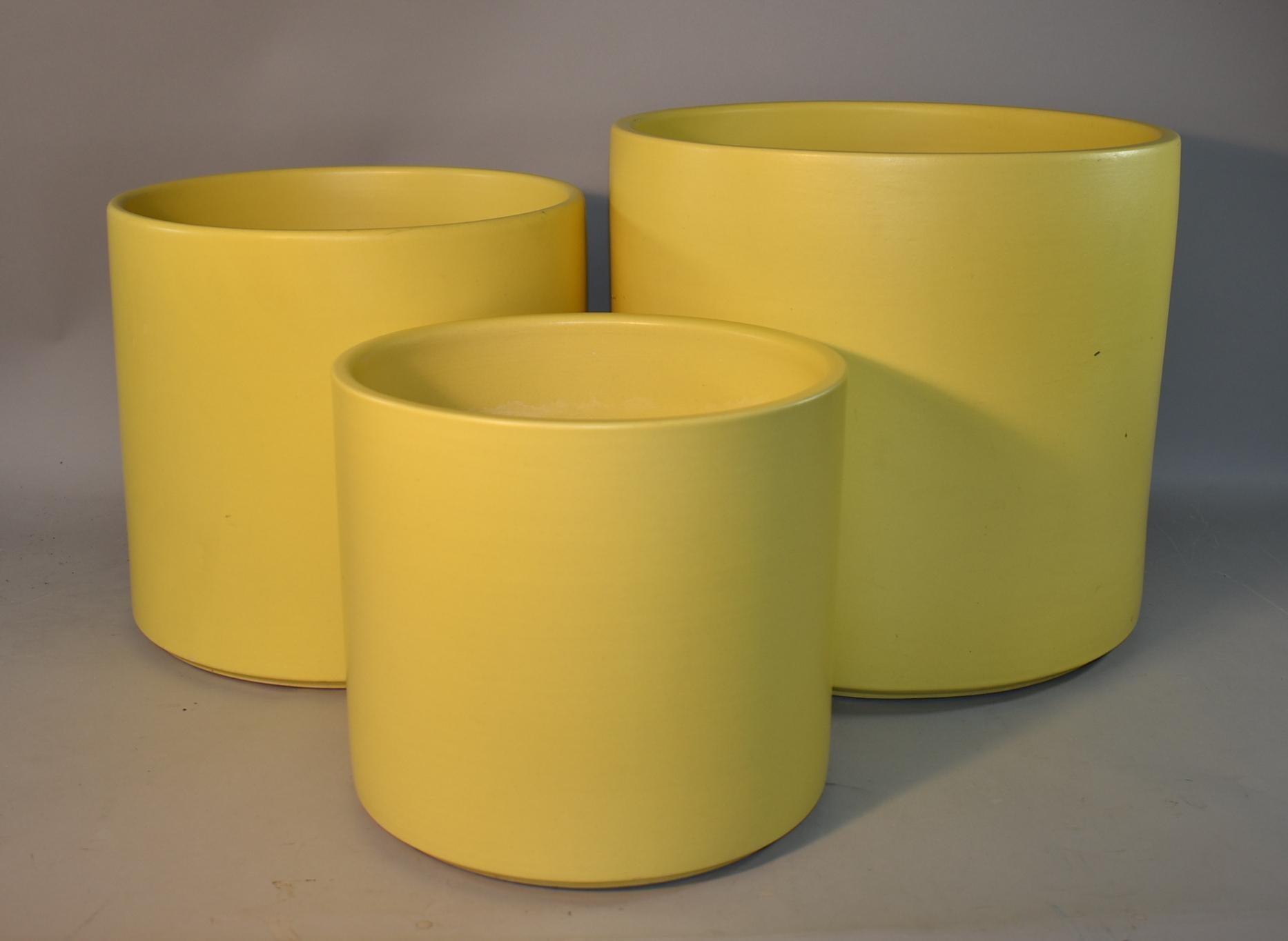 Three various size Mid-Century Modern pale yellow planters by Gainey Ceramics, La Verne CA. Light wear and rub marks. Largest planter s 15.25