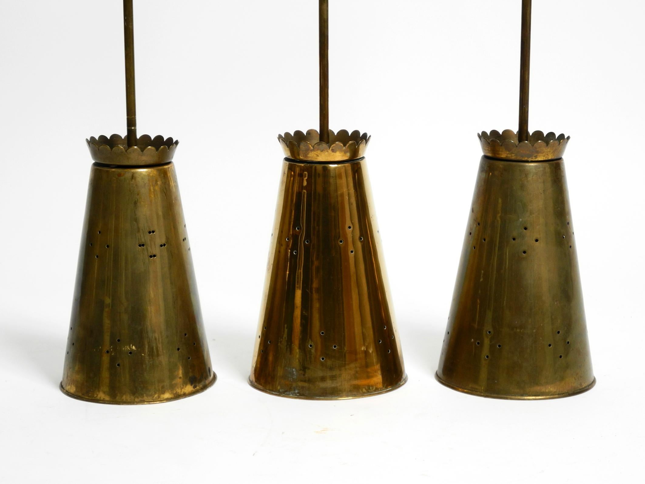 Mid-Century Modern Three Mid Century pendants with a diabolo design in perforated sheet brass