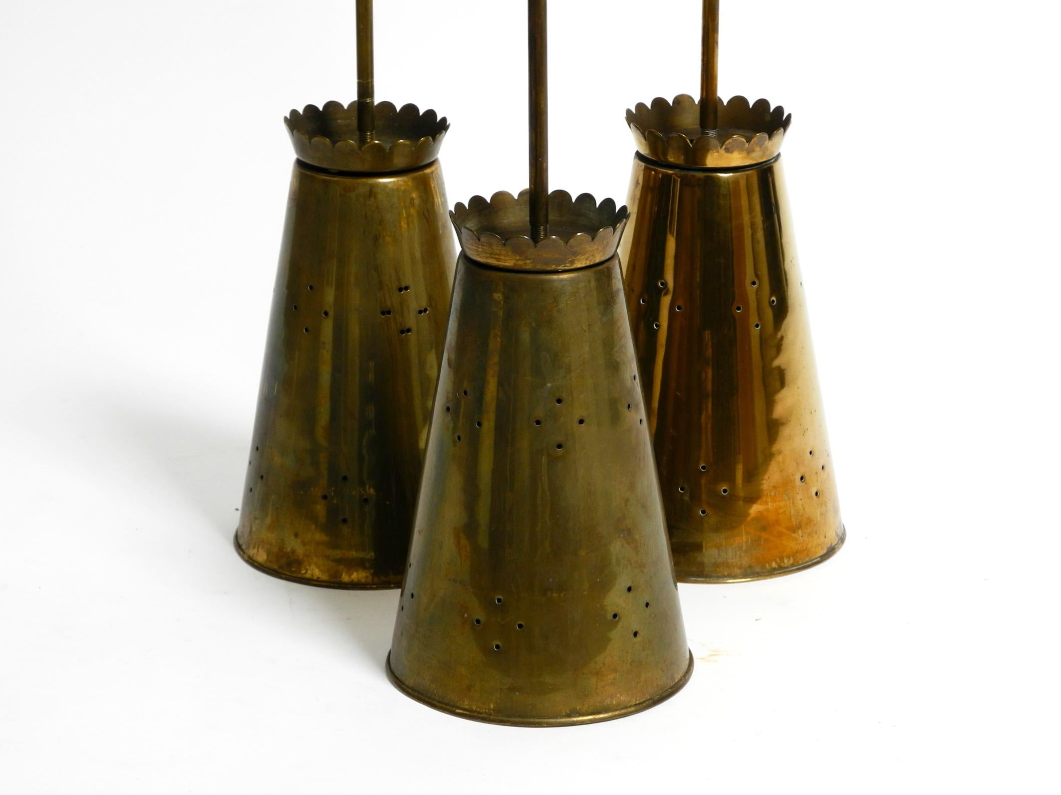 Three Mid Century pendants with a diabolo design in perforated sheet brass In Good Condition In München, DE