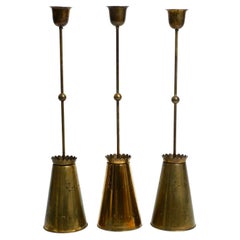 Three Mid Century pendants with a diabolo design in perforated sheet brass