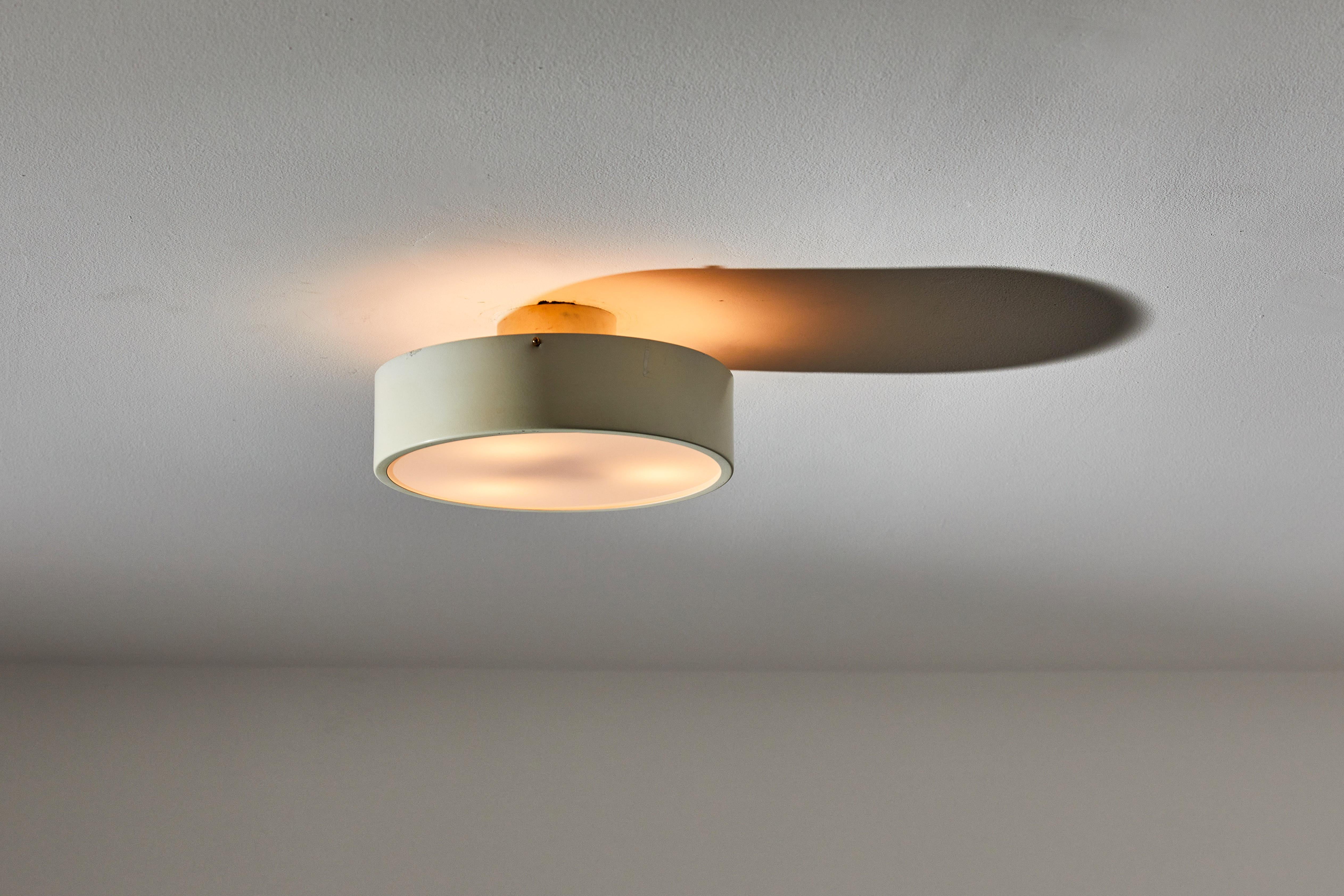 One Model 450 ceiling light by Tito Agnoli for Oluce. Designed and manufactured in Italy, circa 1960s. Original painted aluminum, frosted moulded glass, brass hardware. Rewired for U.S. standards. We recommend 3 E14 40w maximum bulbs per fixture.