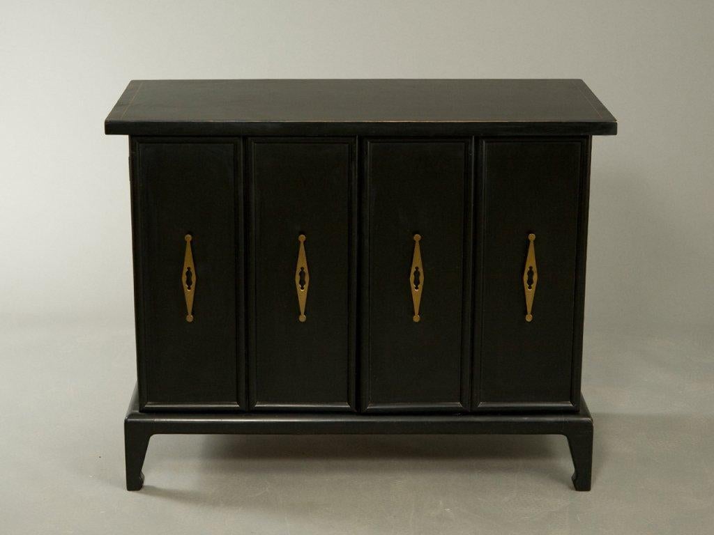 Absolutely stunning modern Asian styling with chinoiserie details three matching units. Lacquered in black, each with rectangular tops over two cabinet doors, the fronts are fitted with brass handles opening to interior storage compartments, raised