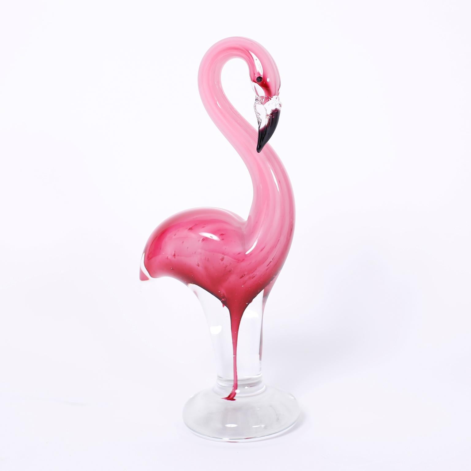 Three hand blown Murano glass flamingos each with graceful form and dramatic color. 

From left to right:

H: 12 W: 5 D: 3.5

H: 8 W: 4 D: 2.5

H: 12 W: 5 D: 3.