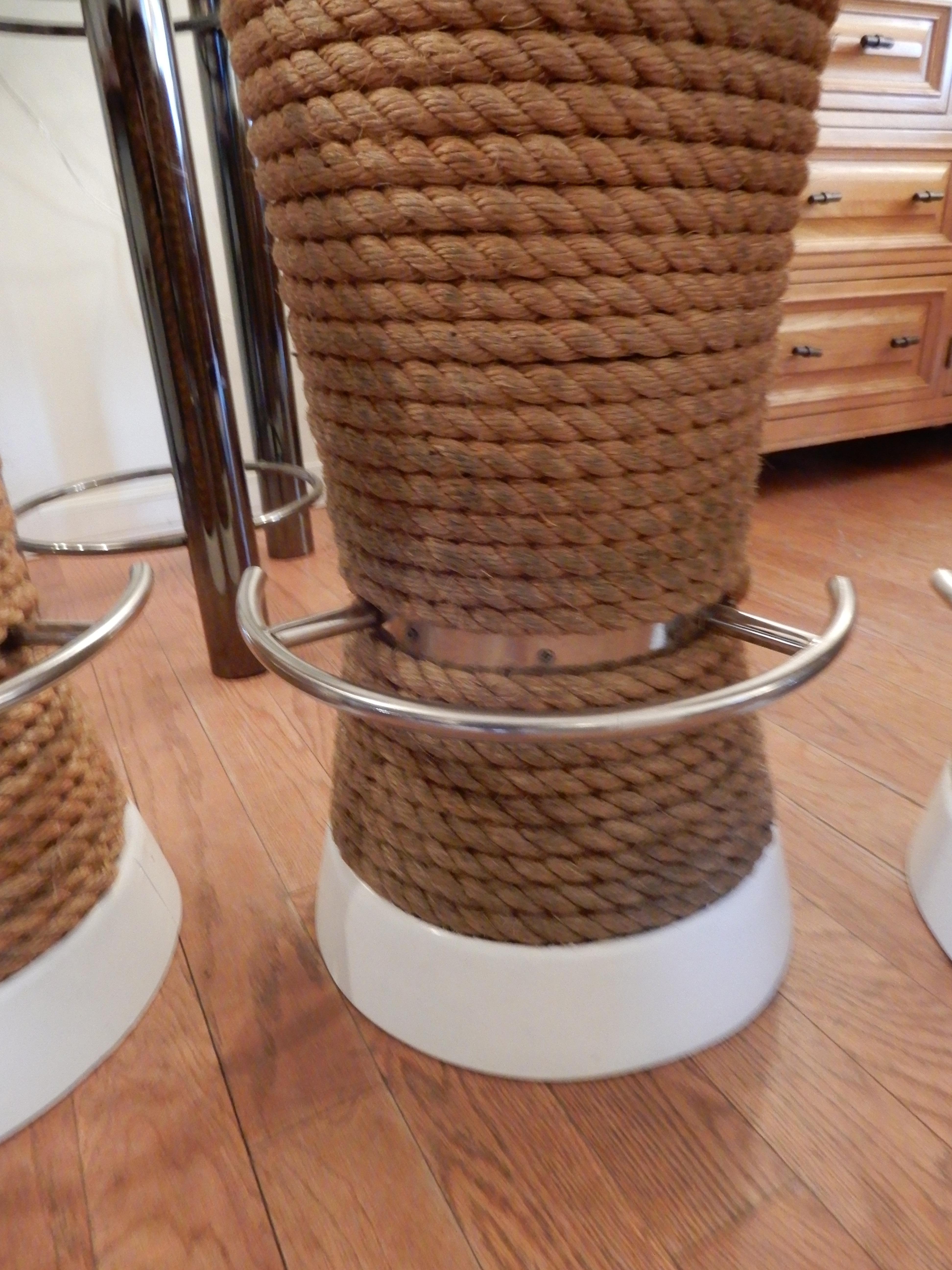 Selling three high bar or counter stools, rope wrapped around teak wood, white tops and bottom band. Polished steel foot rests, heavy duty, made to last, indoor, outdoor.