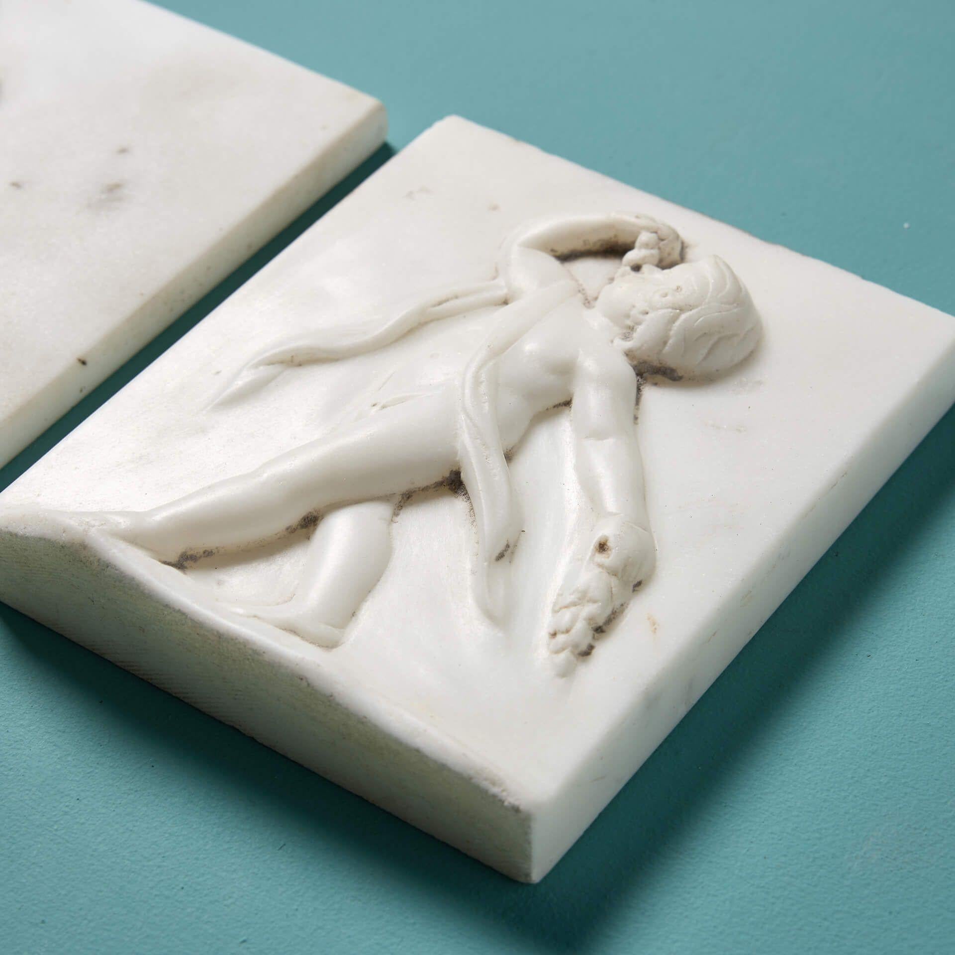 An elegant set of 3 late Georgian era white statuary marble plaques in a neoclassical style, originally used as decoration for the frieze of a fireplace. Dating to circa 1800, these plaques are over 220 years old and are in beautiful condition for