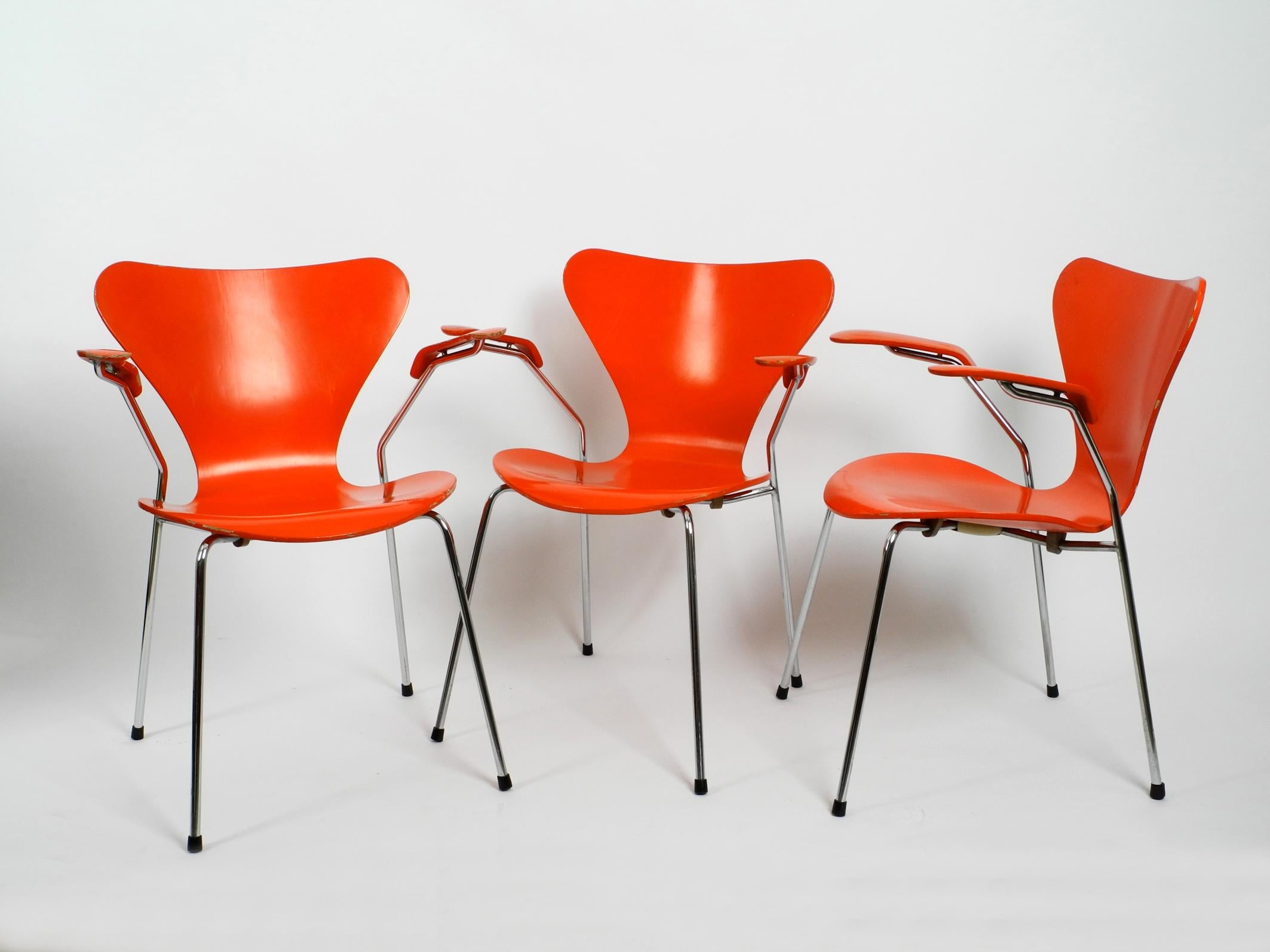 Three original Arne Jacobsen armchairs made of laminated plywood Mod. 3207.
chrome-plated tubular steel frame.
Very rare with the original paint in orange from 1982. 
Made by Fritz Hansen Denmark. With original label on the bottom.
No damages