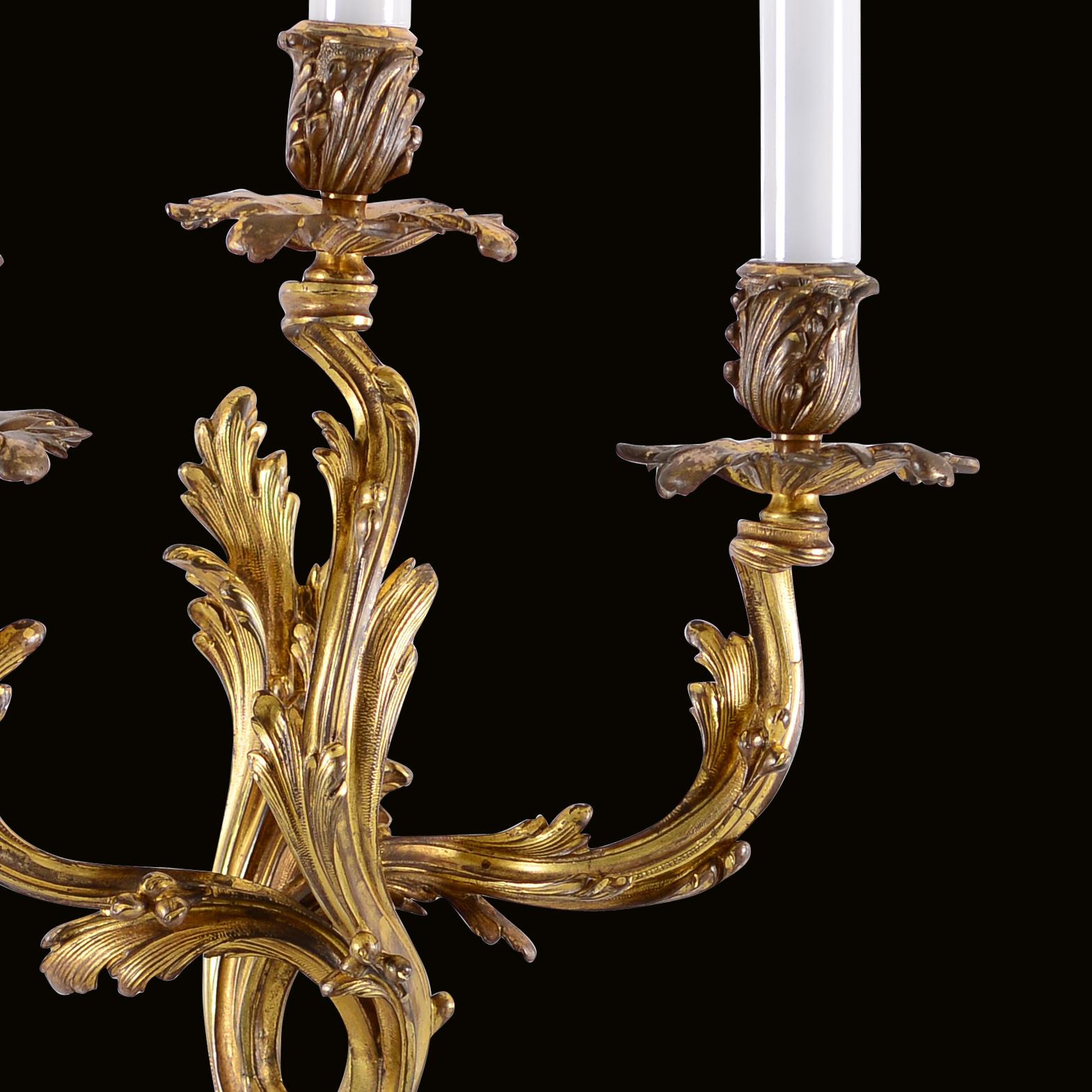 Casted, chased and fire-gilded bronze, very elaborately works, originally with candles, later electrified.