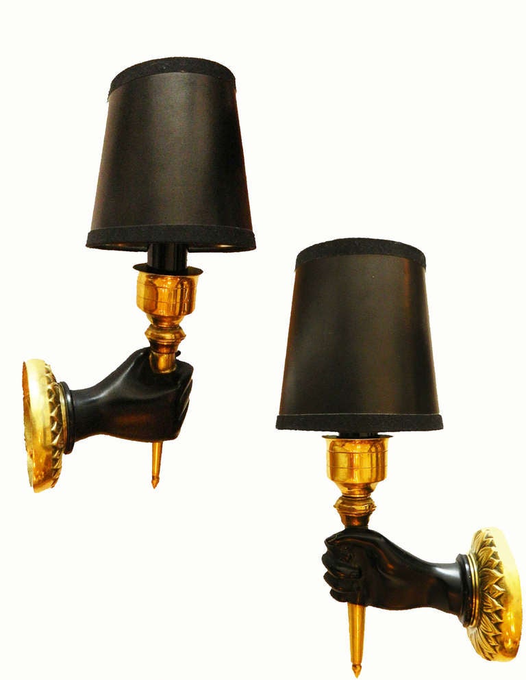 Three pairs of Andre Arbus wall sconces. Bronze back plate and painted bronze hand. Nice and original old patina.
10
