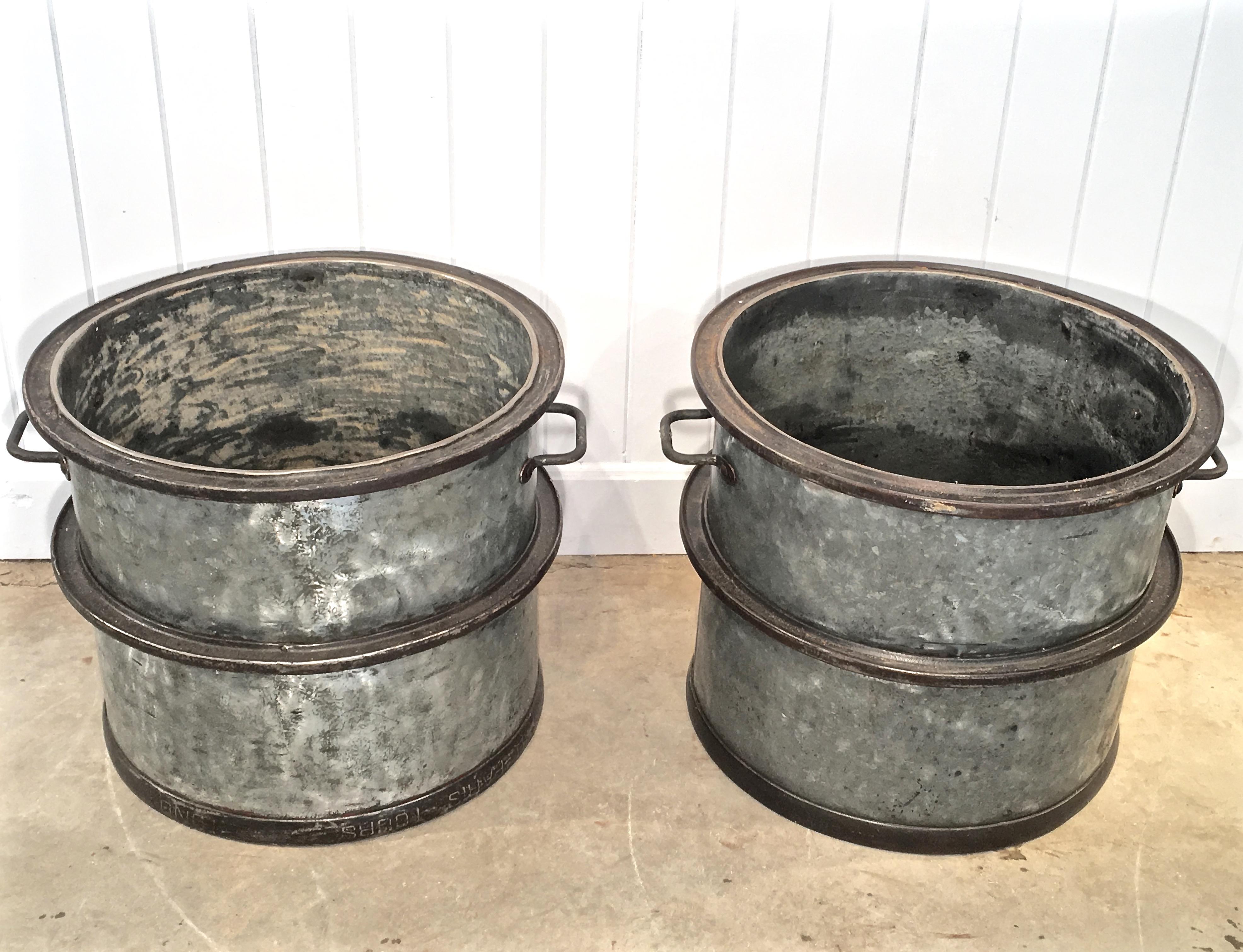 These heavy polished steel tubs are simply fabulous! Made of heavy industrial galvanized steel with original cast iron rims and handles, they can handle huge plantings, including topiary. Because they are galvanized, you never have to worry about
