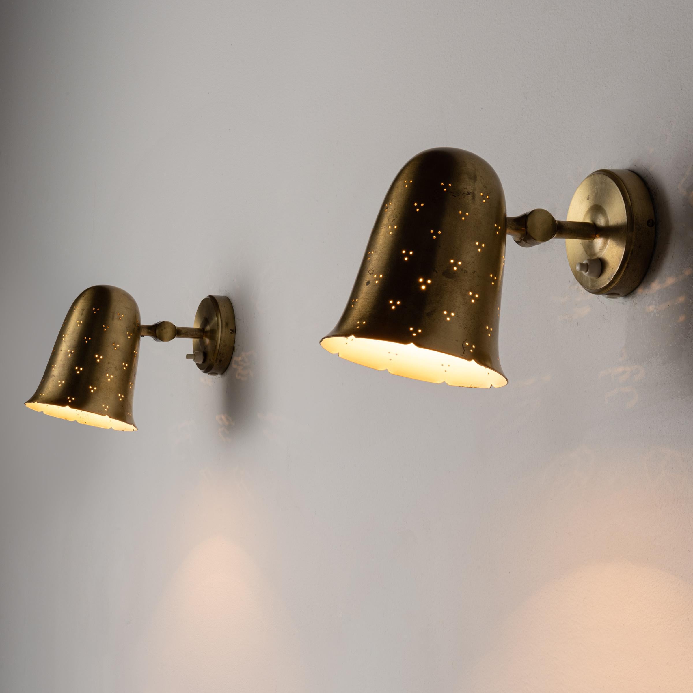 Pair of Sconces by Boréns Borås. Manufactured in Sweden, circa 1950's. Brass shades articulate to various positions. Rewired for U.S. standards. We recommend one E27 75w maximum bulb per fixture. Bulbs not provided.