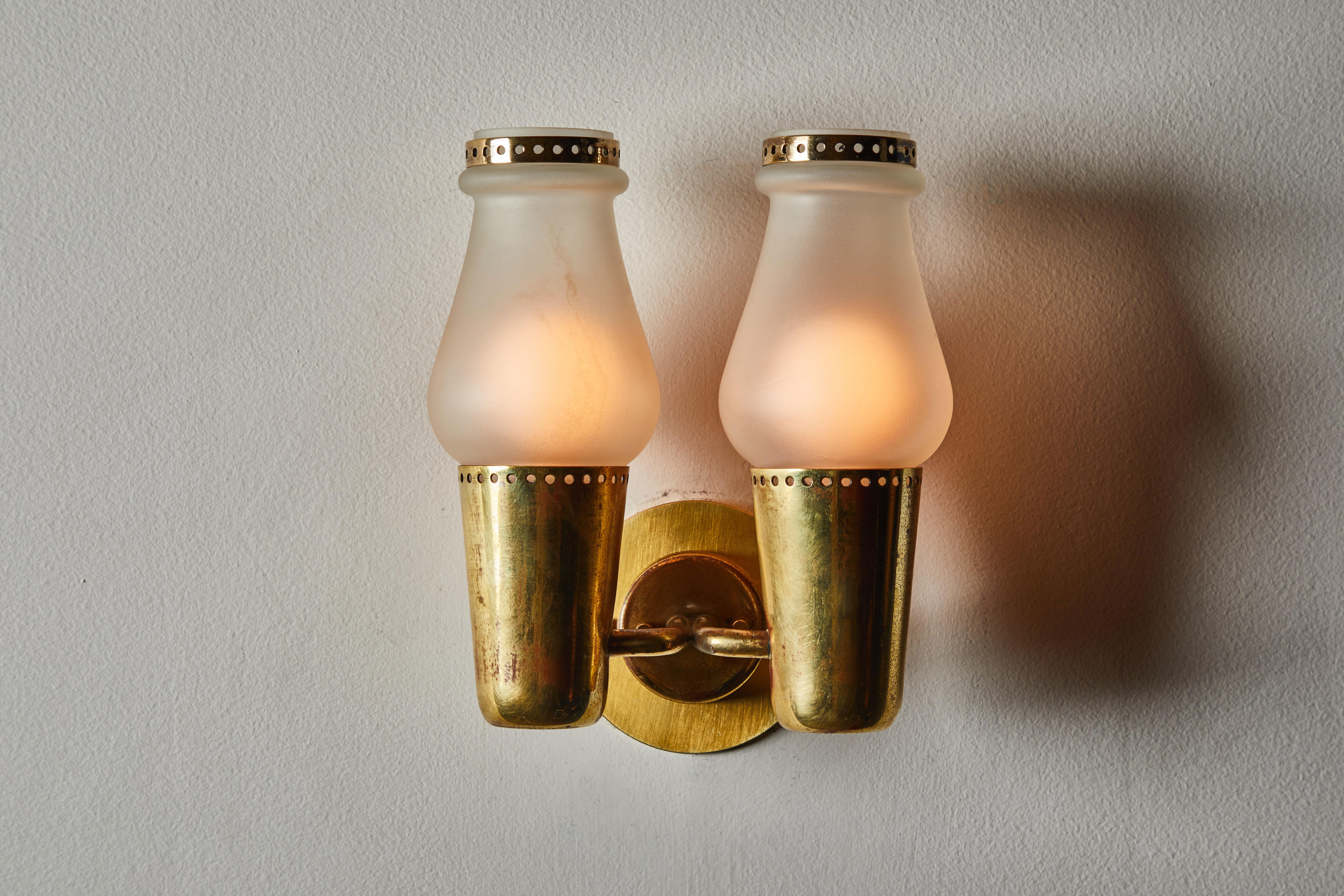 One pair of sconces by Gino Sarfatti. Manufactured in Italy, circa 1950s. Glass diffusers with brass hardware. Rewired for US junction boxes. Each light takes one E27 100w maximum bulb. Only one pair available