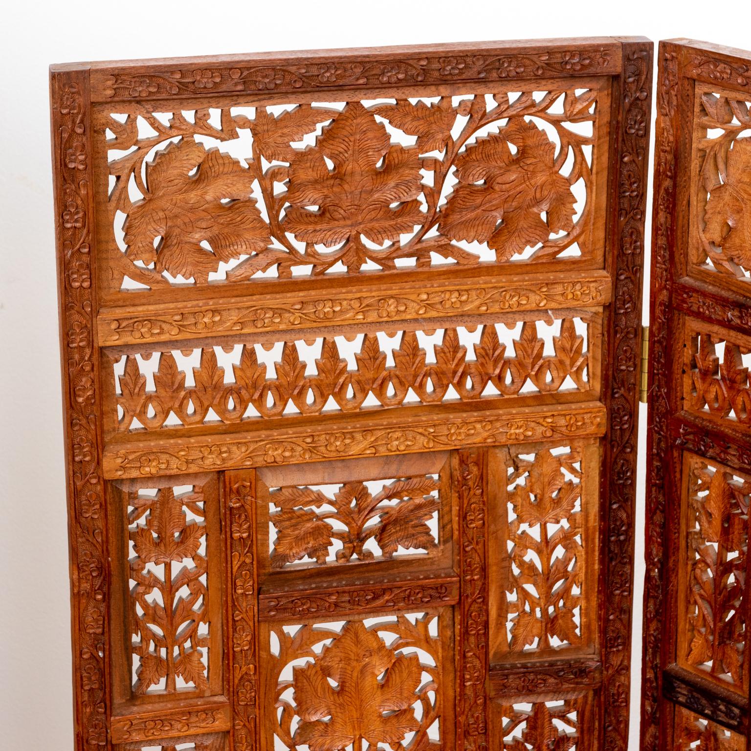 Three panel Anglo-Indian style screen decorated with various panels of geometric tracery in the shape of foliage and flowers. Please note of wear consistent with age including minor finish loss.