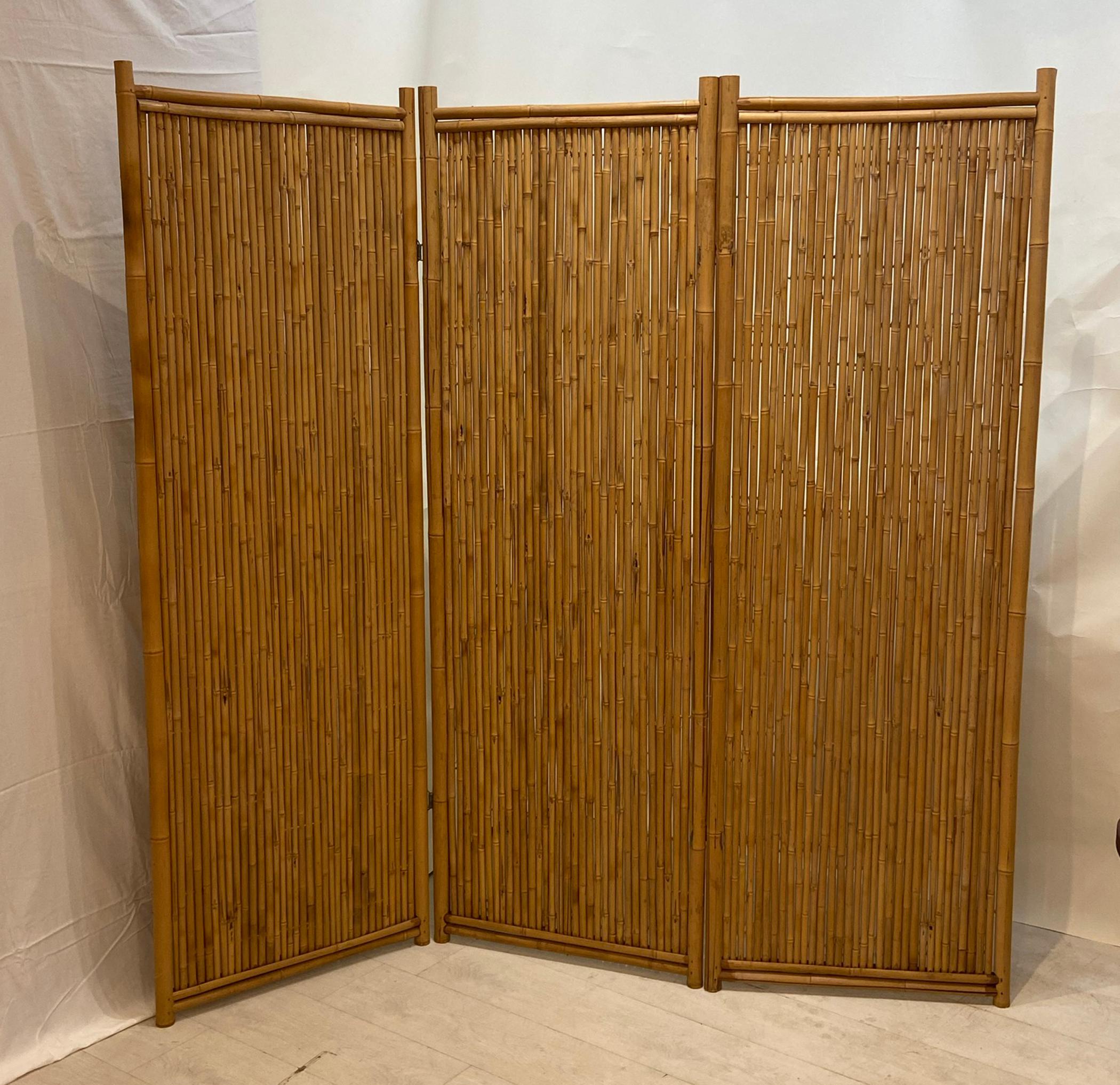 Large three panel bamboo screen. An older well constructed bamboo screen. Good even natural golden finish. Wire type hinges nice large screen