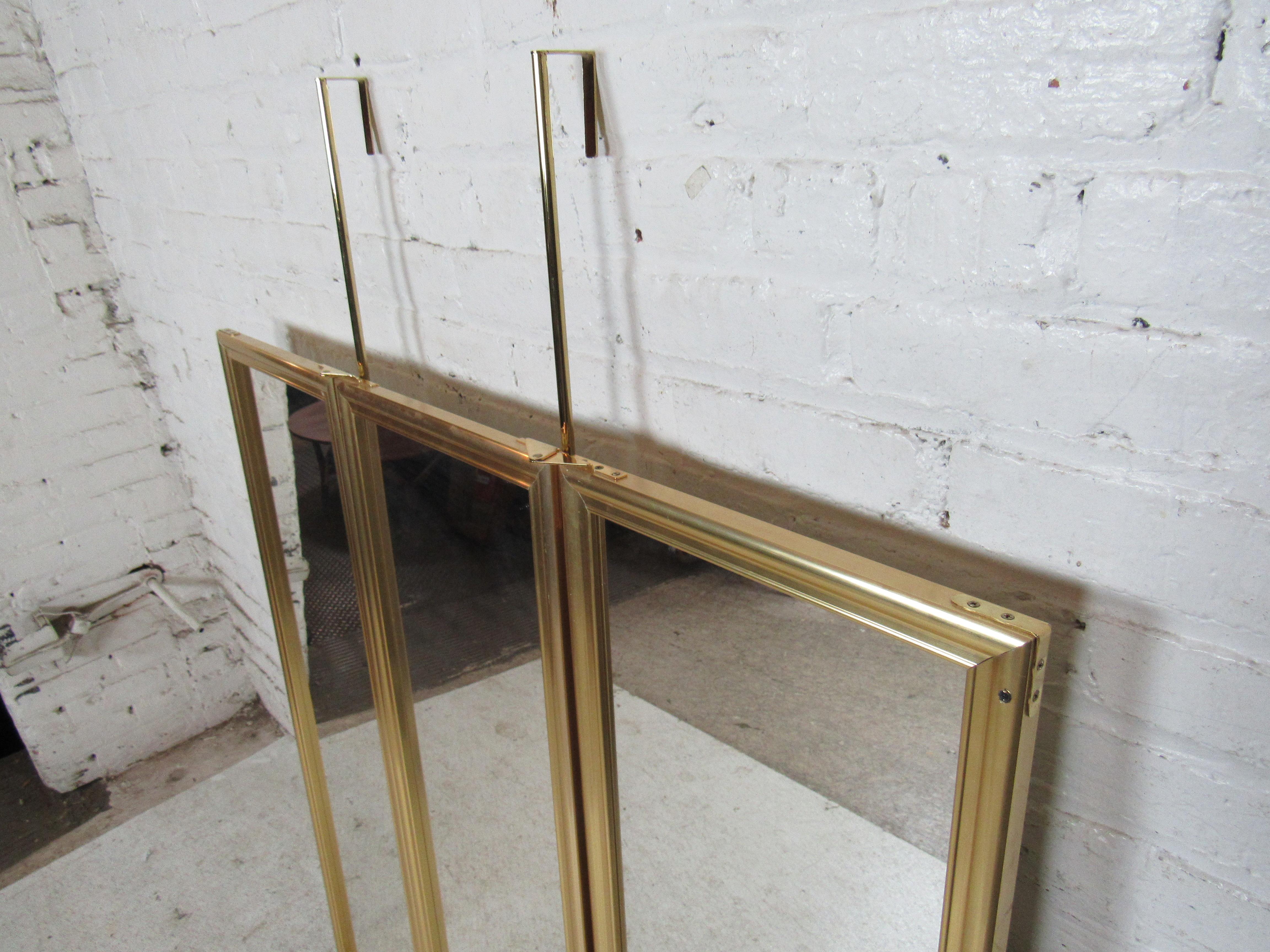 Brass frame door hanging mirror with three panels. Can open to three mirrors, or close to a single mirror.
(Please confirm item location - NY or NJ - with dealer).  
   