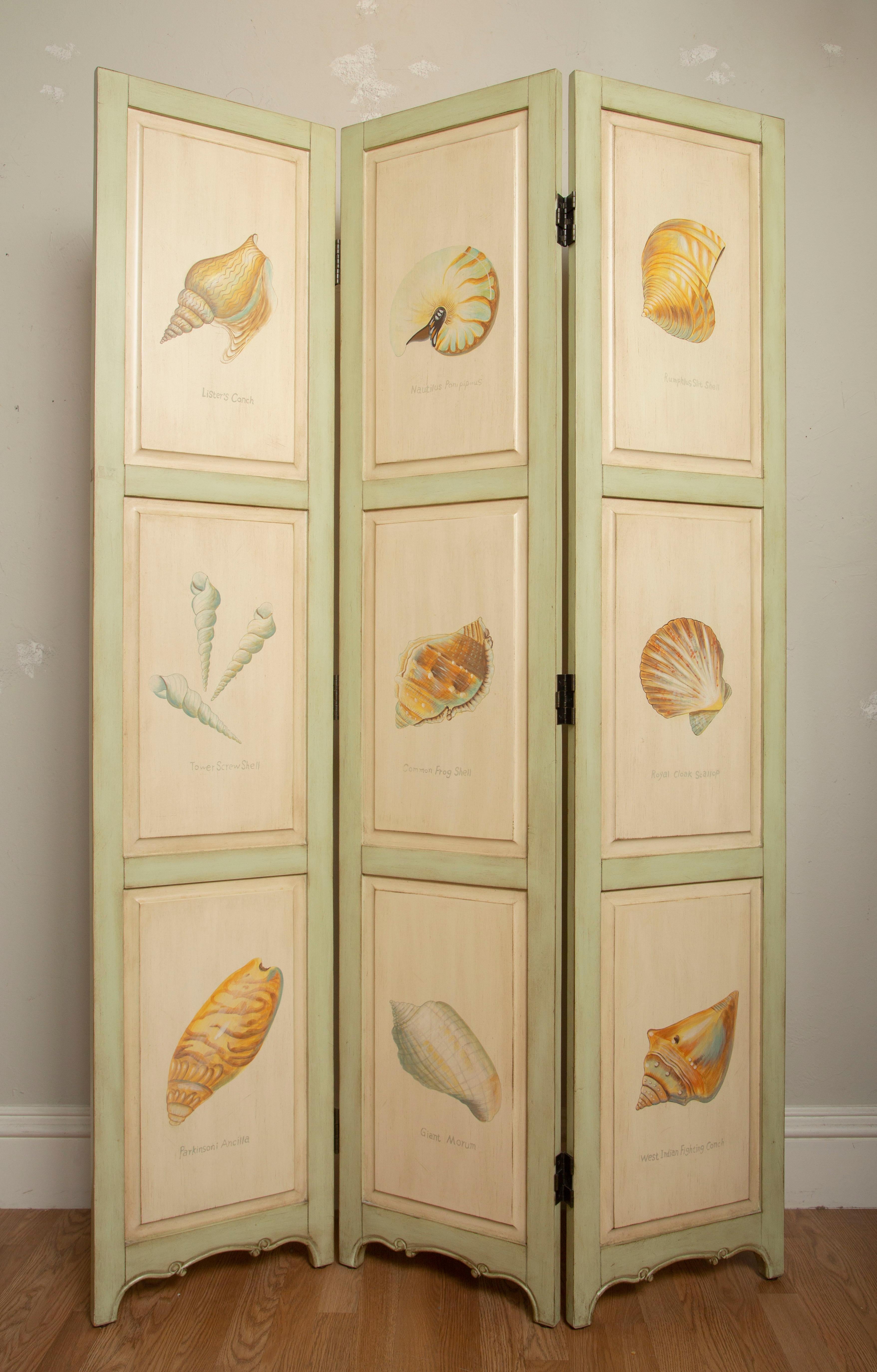 Three-panel hand painted screen depicting a variety of sea shells on the front and solid painted panels on reverse. Screen has three panels each 16