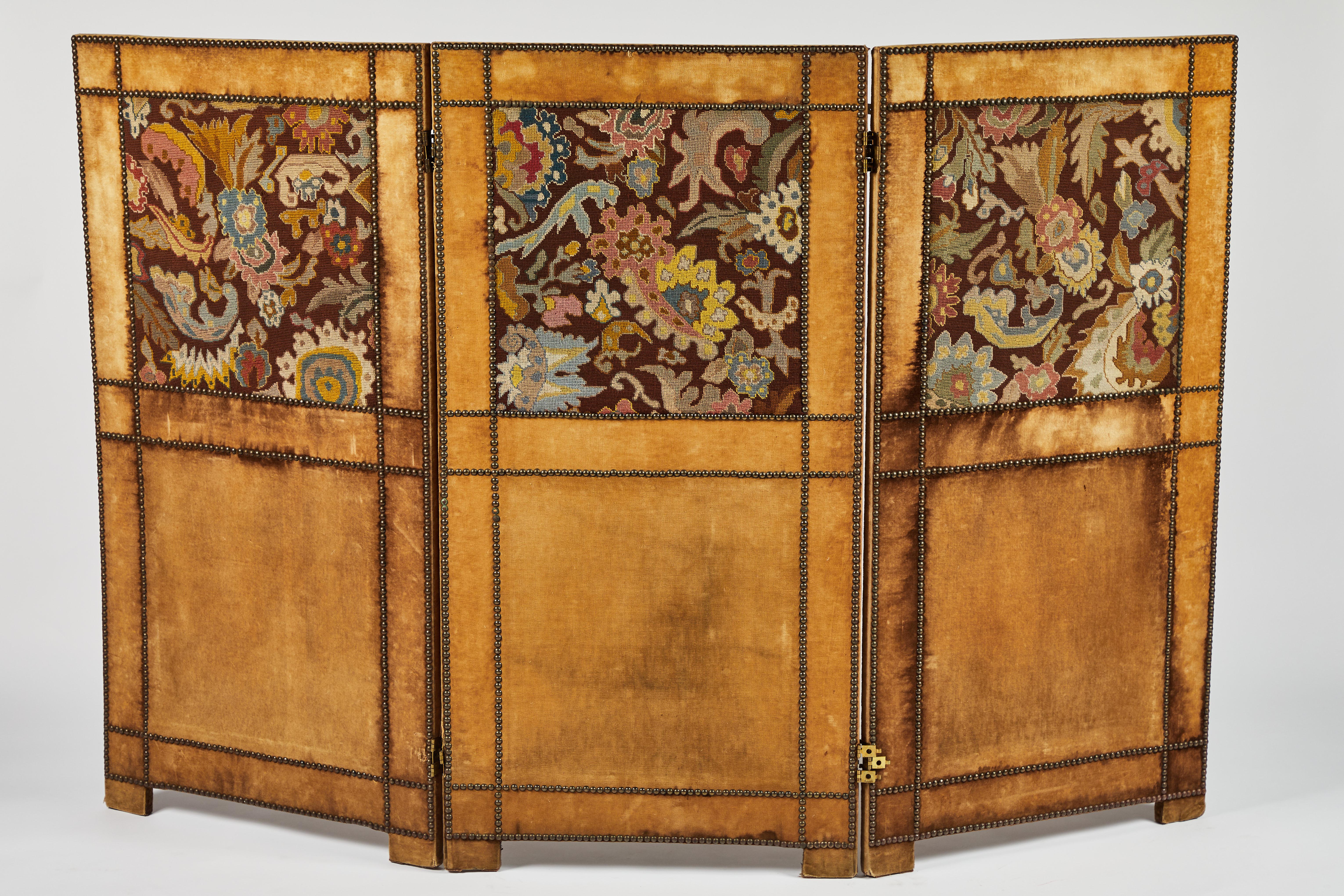 Three-panel velvet upholstered folding screen or room divider with inset European tapestry fragments. Each side panel is clad in a vivid wool tapestries and framed with gold velvet. Decorative brass nailhead trim.
Works wonderfully as a headboard!