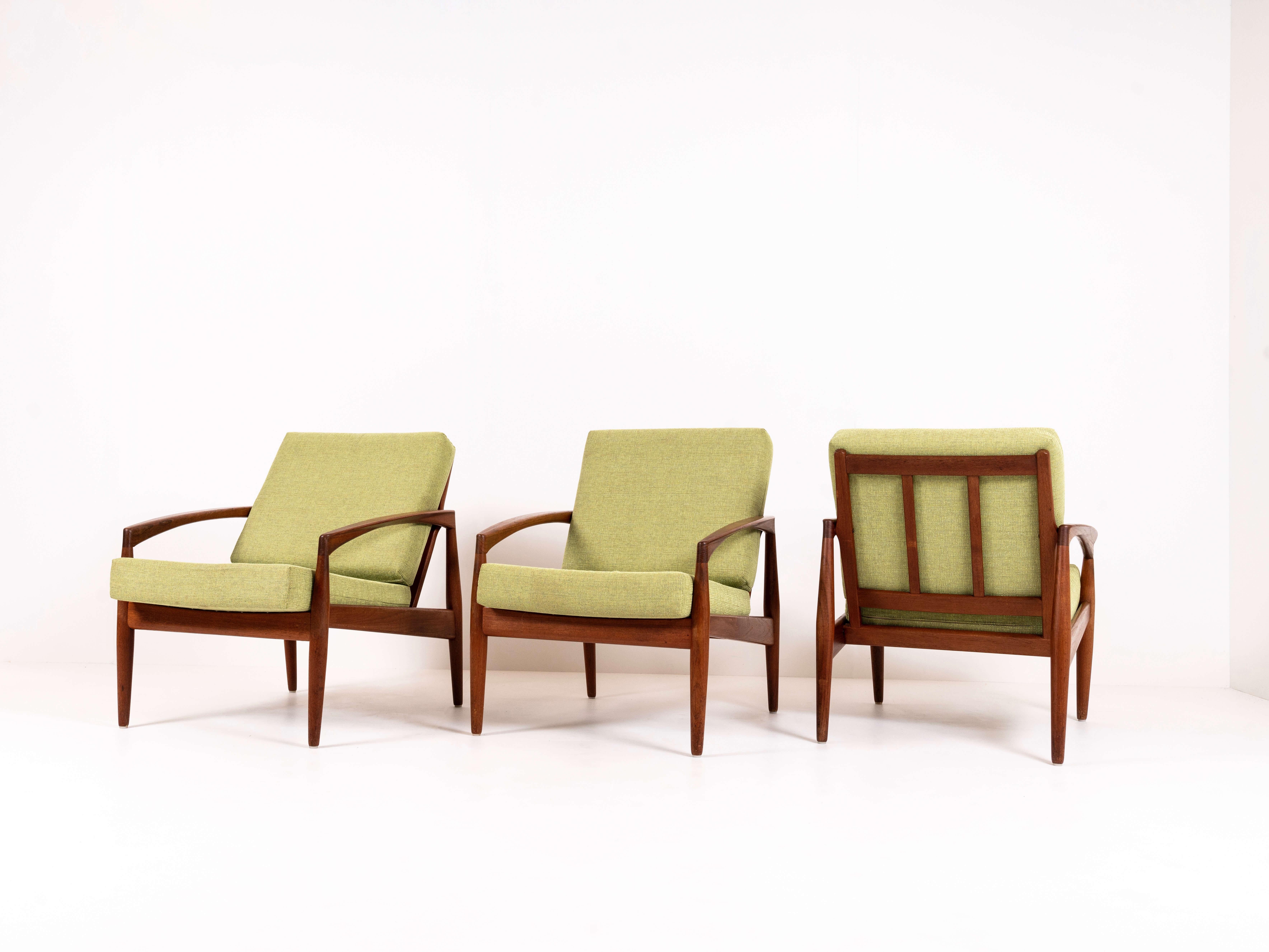 Set of three paper knife chairs, model 121, by Kai Kristiansen for Magnus Olesen from Denmark 1960s. These chairs in teak have a truly an iconic, organic design; round arm rests and a backrest that is slightly moved backwards for comfortable