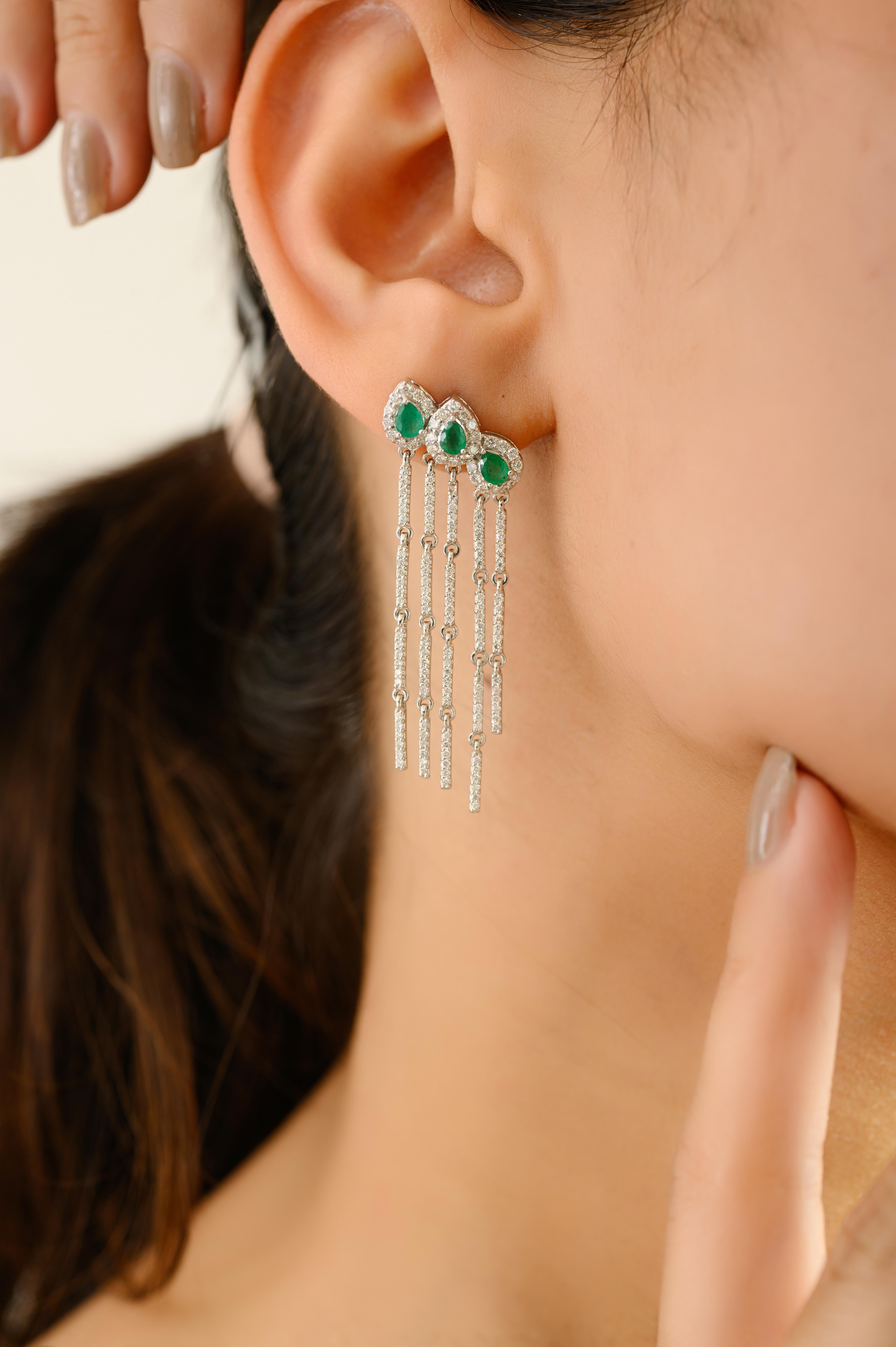 Elevate your elegance with these stunning 18K white gold chandelier earrings, featuring a trio of pear-shaped emeralds (0.78 carats total) that exude rich, verdant beauty. Each emerald is haloed by shimmering diamonds and gracefully accented by