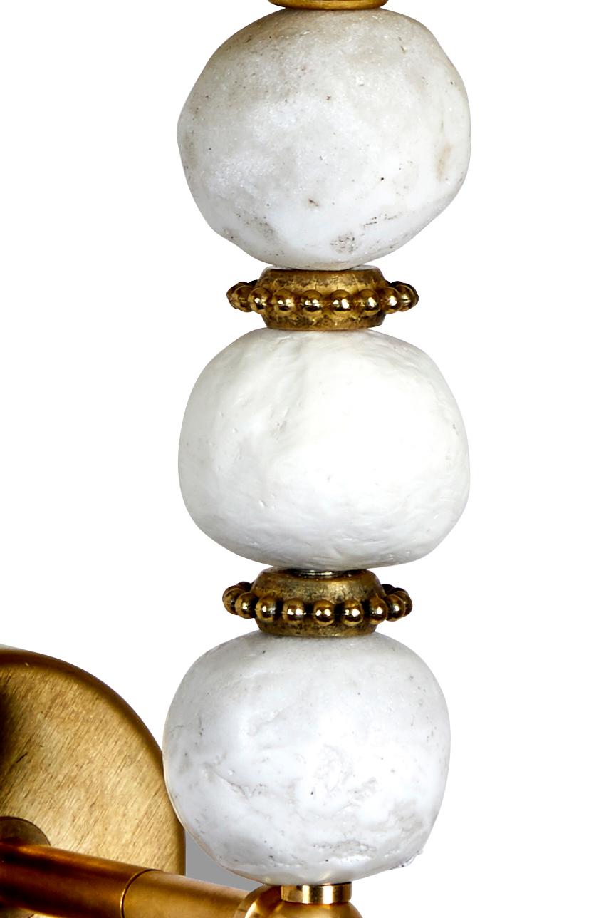 This handmade Margit Wittig wall light (sconce) features three organic, white resin shaped pearls with brass detail. The sconce is made by Artist and Sculptor, Margit Wittig in her London Studio. Available in various finishes - see below. 

Margit