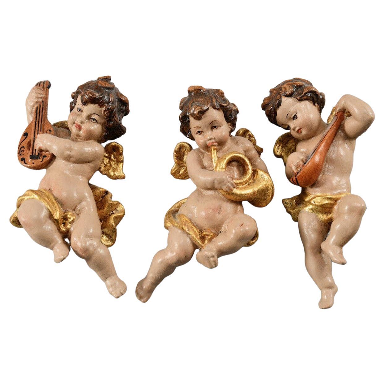 A set of three beautiful petite hand carved cherub angels, found at an estate sale in Verona Italy. Made by a woodcarver in the South Tyrollean Area in Italy, this area is well-known for their wood carvings. The size given in the dimensions section
