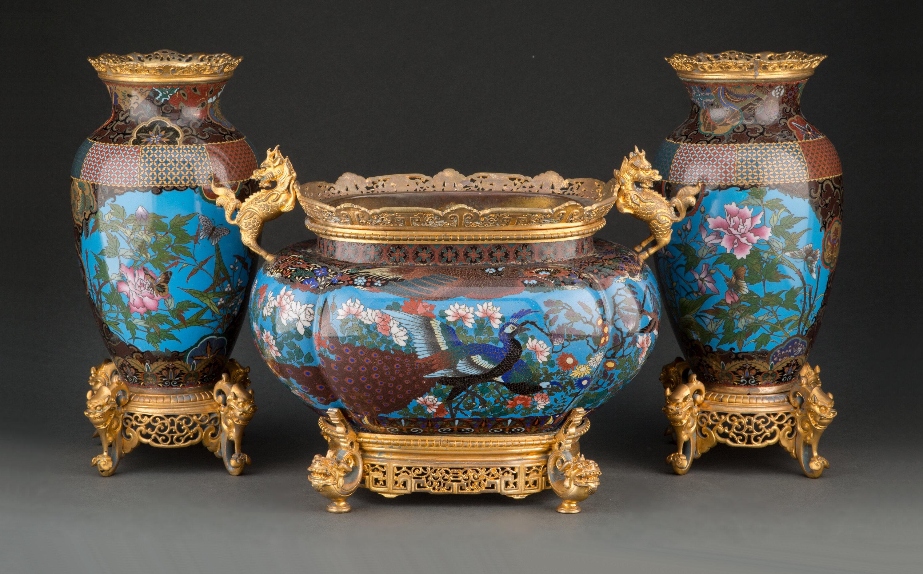 Finest quality three piece chinoiserie style 19th century French bronze mounted Cloisonne enamel Garniture set comprising a pair of vases and a centerpiece.  The bronze mounts are French 19th century and the Cloisonne enamels are Japanese Meiji