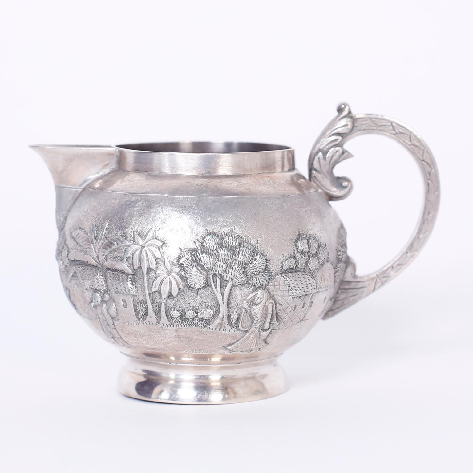 Refined three-piece antique Anglo-Indian tea set with scrolled acanthus leaf handles and hand chased depicting landscapes with animals and palm trees. Signed Goopee Nath Dutt, Calcutta.
Measures: Milk: H 3.25, W 5, D 3.5
Tea: H 5.5, W 7.25, D