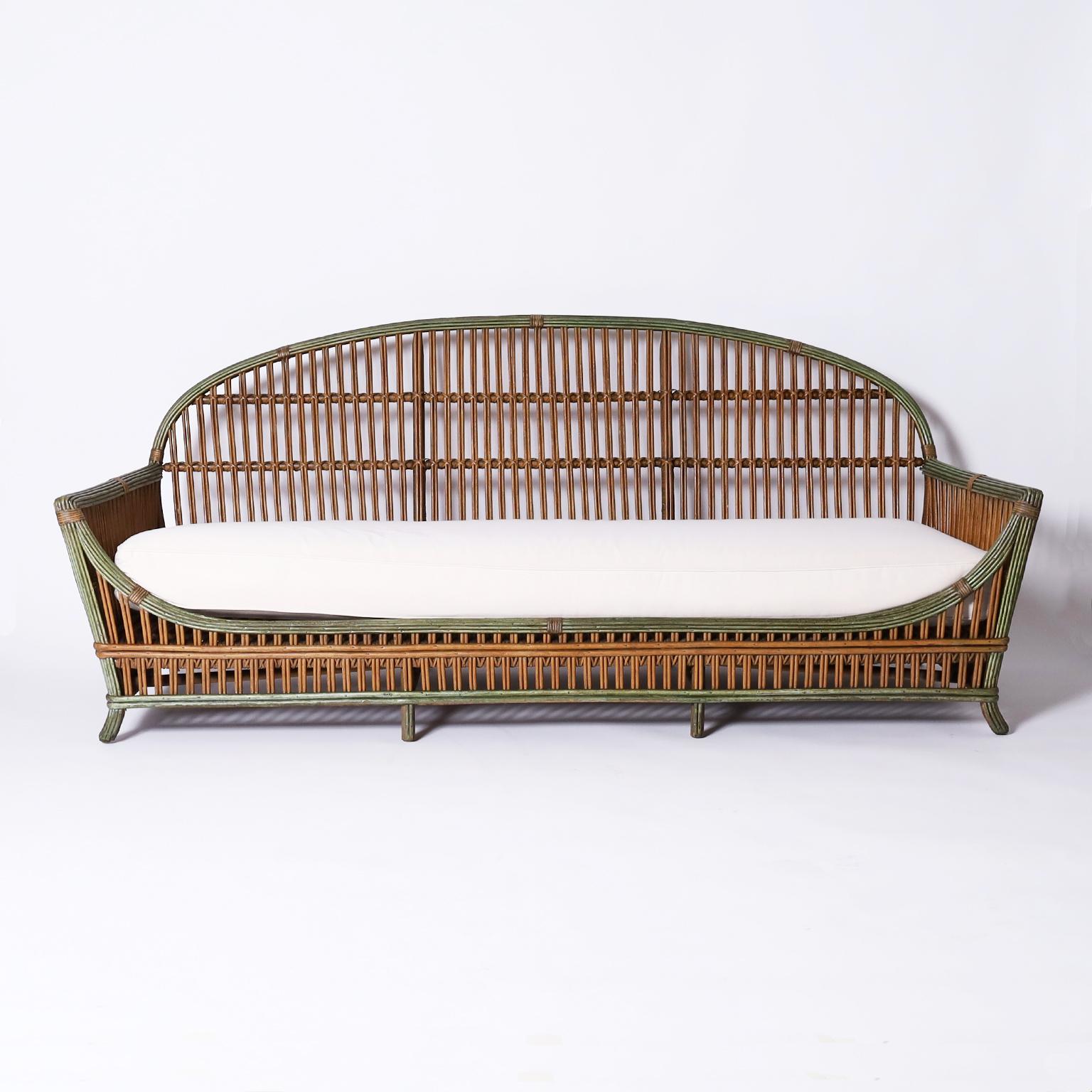 Three piece rattan suite consisting of a sofa, armchair, and table in remarkable condition with original paint and having bold art deco stream line form. For sale as a set and priced individually, your choice.
.
Sofa – H: 32 W: 80 Depth: 34.