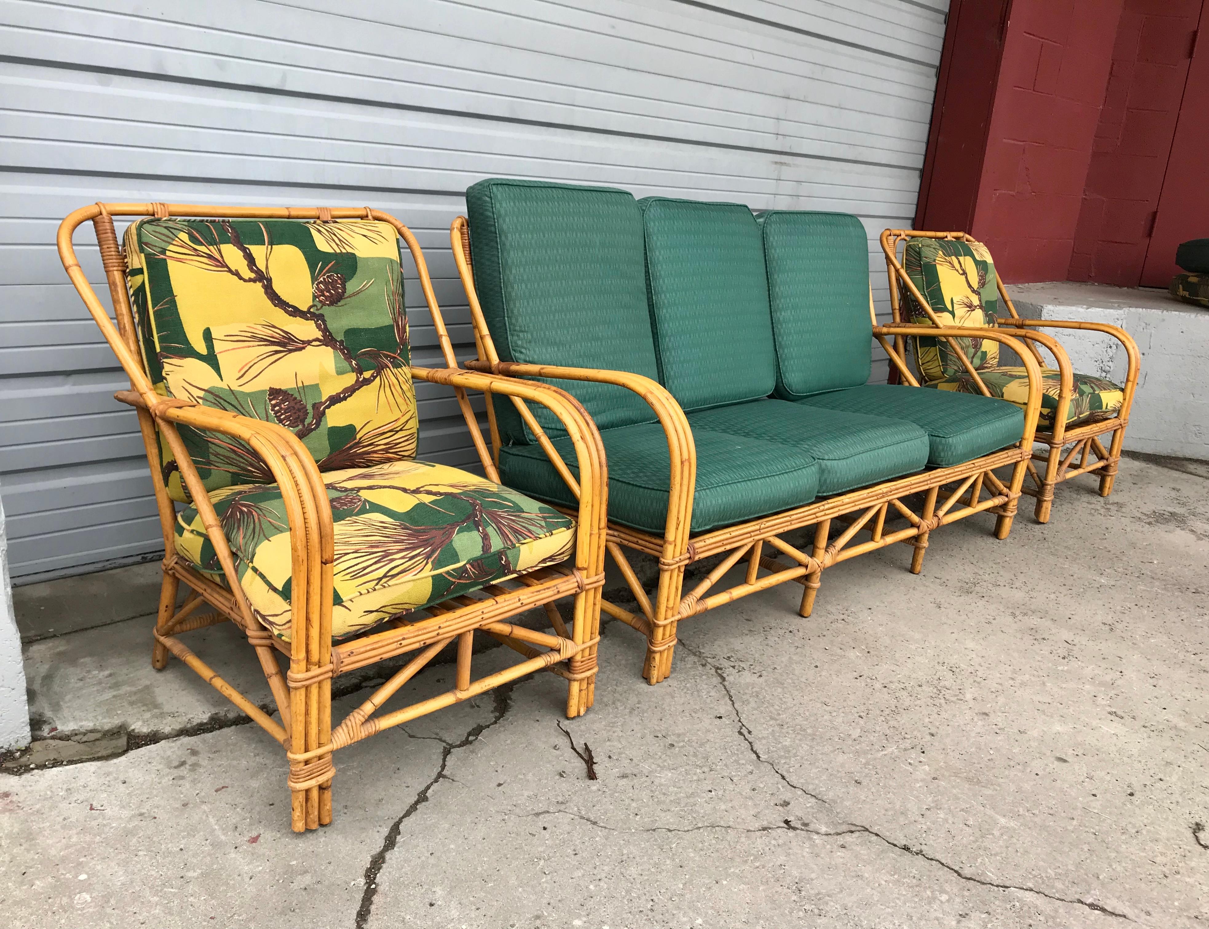 three-piece bamboo/ rattan indoor or outdoor living room suite attributed to Ritts Tropitan, stunning Art Deco streamline design. Sofa and two chairs, Amazing original warm patina, set retains its original cushions, two chairs, original stylized