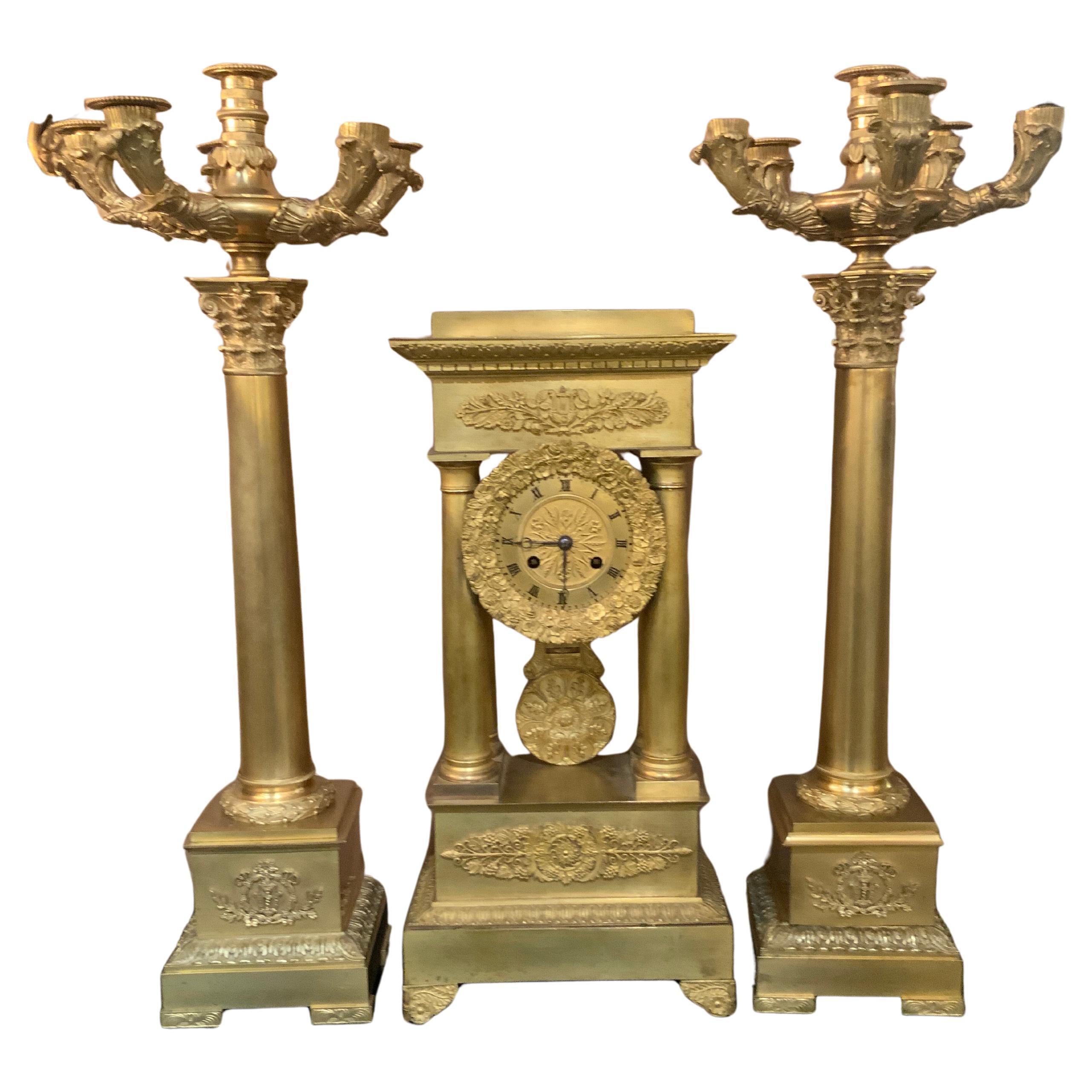 Three piece bronze dore empire clock with pair of candelabrum For Sale