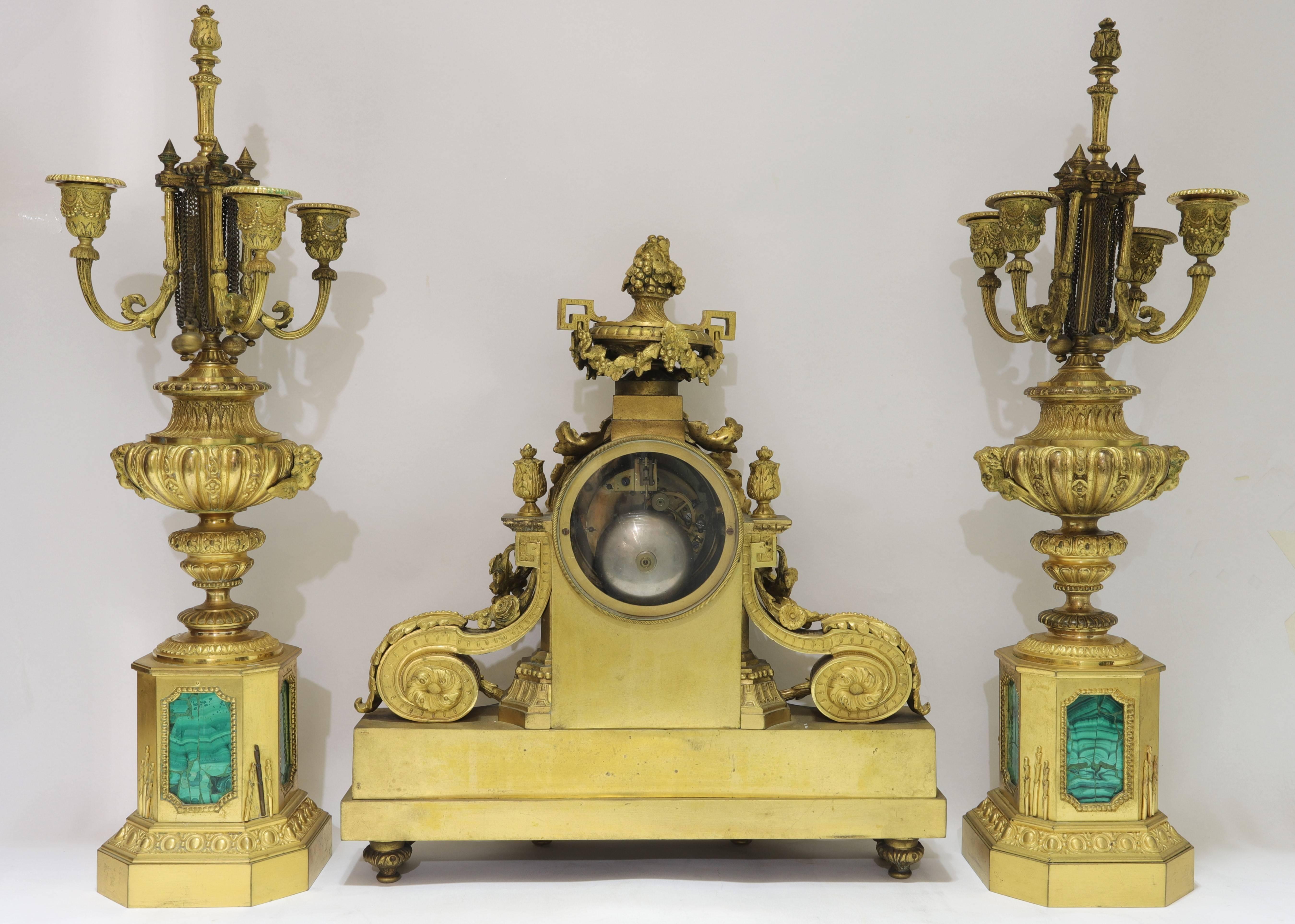 Very fine quality Louis XVI style gilt bronze and Malachite three-piece clock and candelabras clock set.
The dial signed