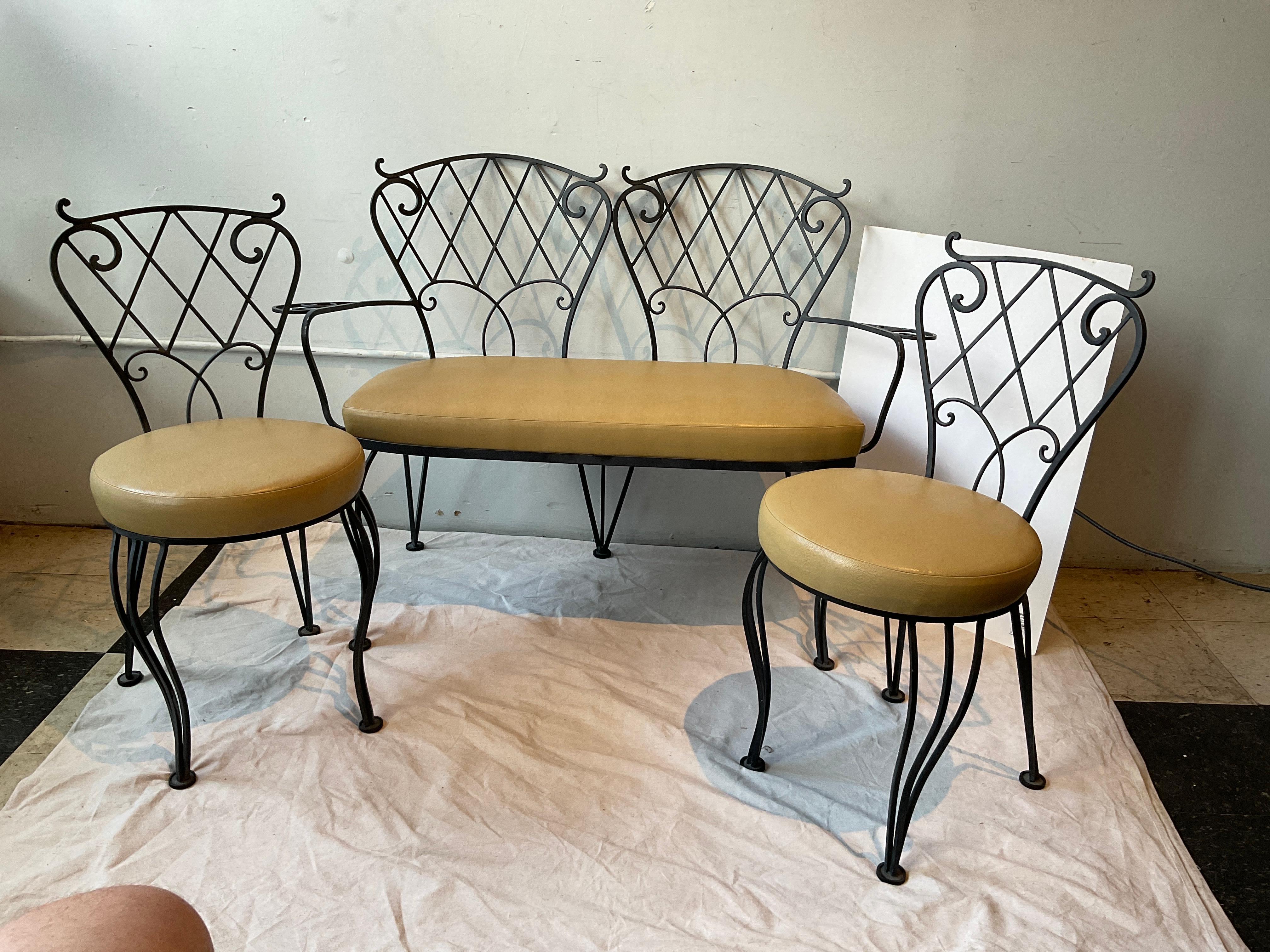 Three piece decorative iron garden set. Settee and a pair of chairs.