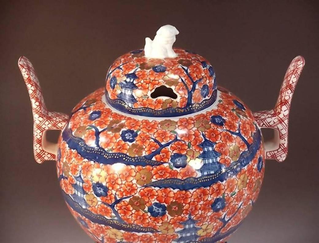 This three-piece porcelain decorative incense burner vessel, hand-painted on a beautifully crafted porcelain body, is a signed masterpiece by Fujii Tadashi, widely respected award-winning Japanese master porcelain artist in Imari-Arita tradition.