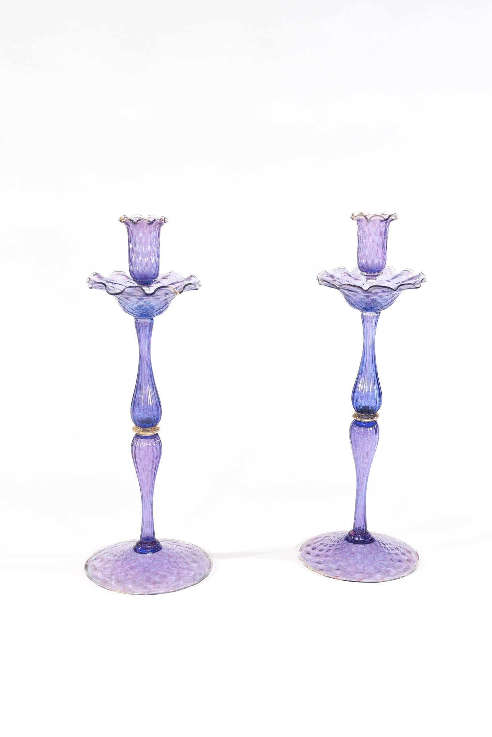 Your table will be magnificent when you set it with this three-piece centrepiece set of handblown Venetian glass. The unusual and rare color of amethyst/lavender is highlighted with gold leaf inclusions. The tall and elegant candlesticks rise above