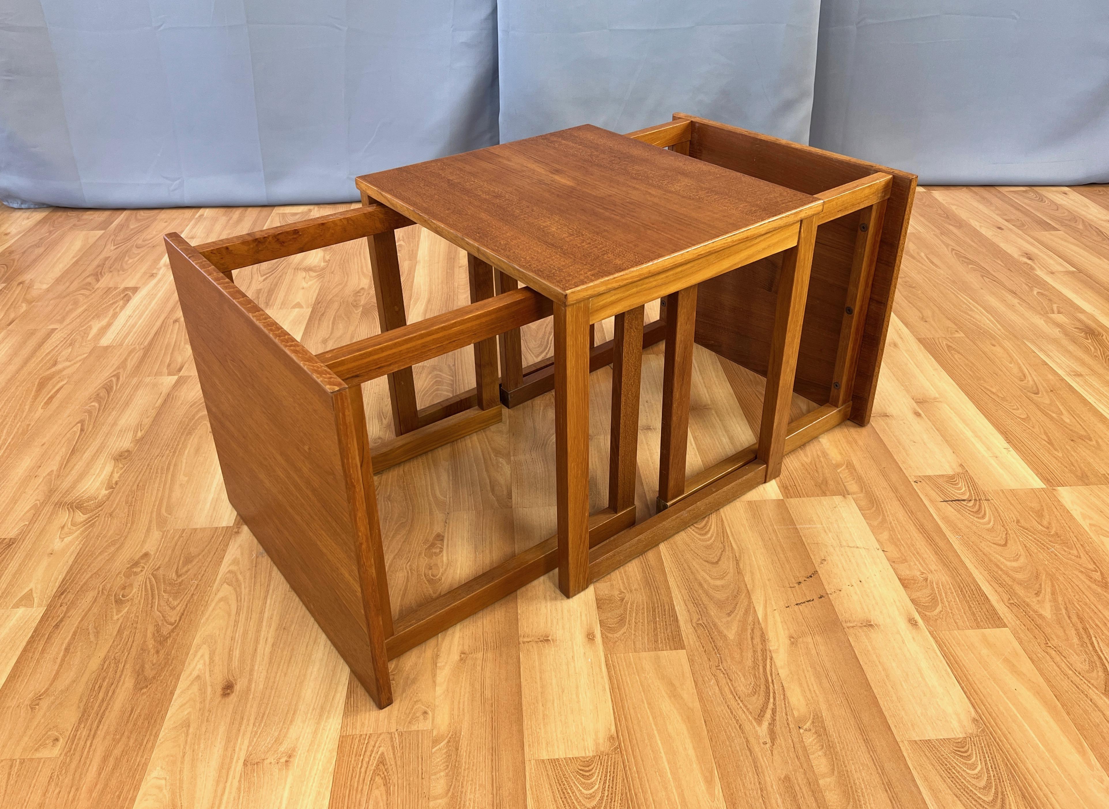 A three-piece set of 1960s Danish modern Model 33 teak interlocking cube nesting tables by Kai Kristiansen for Vildbjerg Møbelfabrik.

Clean and clever design features three side or occasional tables with equal-sized tops and precisely positioned