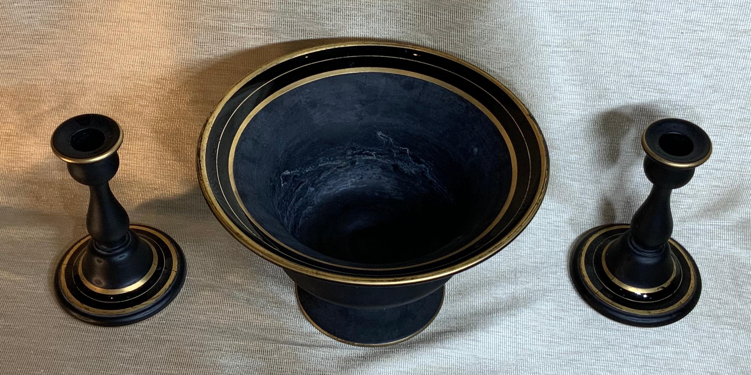 Elegant set of black pressed glass with hand painted gold trimming of one center bowl and pair of matching glass candlestick. Beautiful decorative set.
Candlestick size: 6.25” high x 4” wide
Bowl size: 9.75” wide x 6.25” high.
