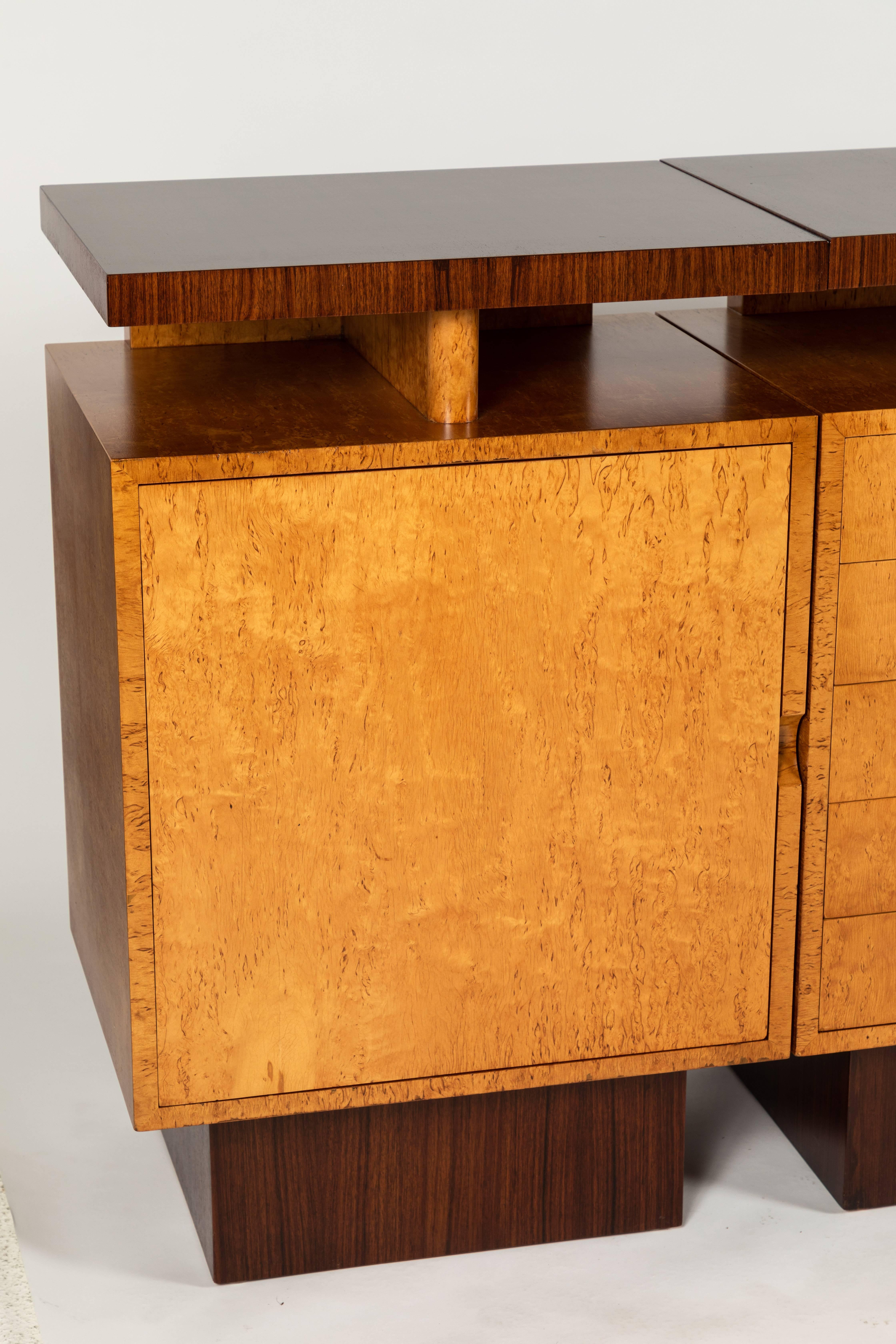A fine three-piece, two-tone sideboard by Andrew Szoke that embodies the Mid-Century Modern movement.
Veneered in a combination of bird's-eye maple and Macassar ebony for a high contrast.

The smaller cabinets feature one door concealing three