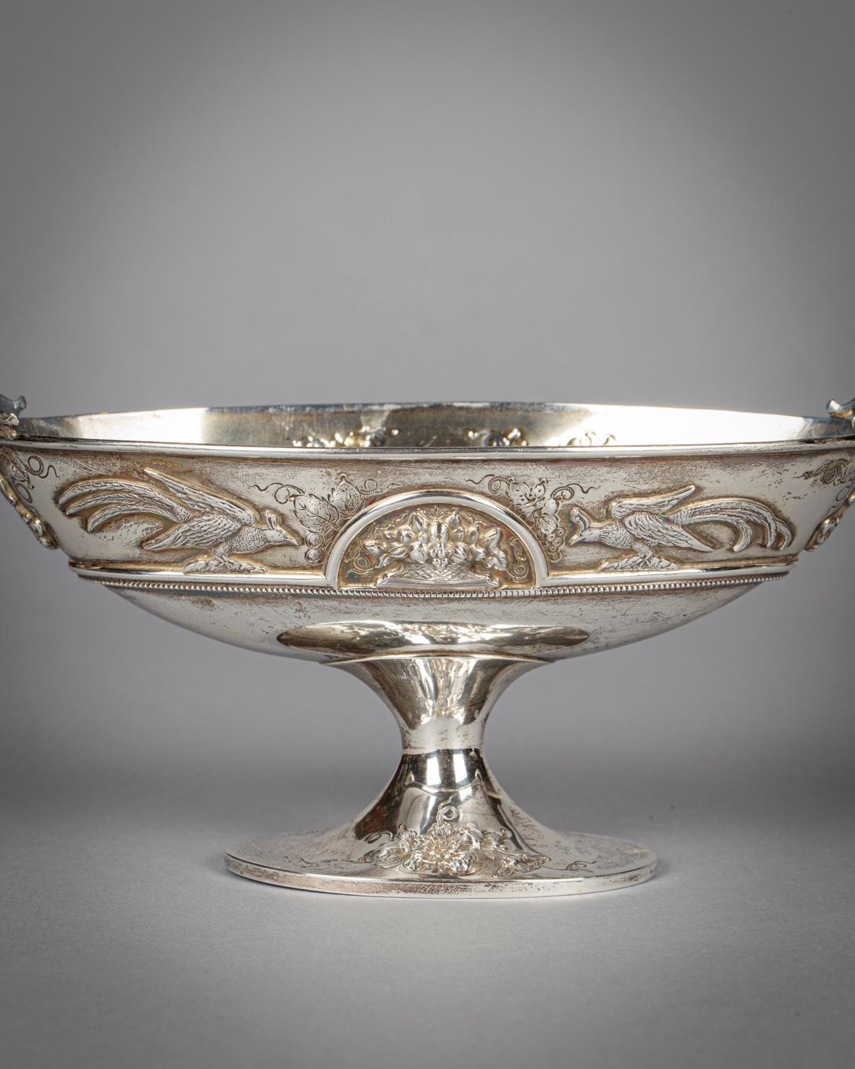 Marked Barbour Silver Co. in Hartford CT. Chased with birds flanking an arched containing flowers and fruit in a basket, with laurel and berry ringed handles.