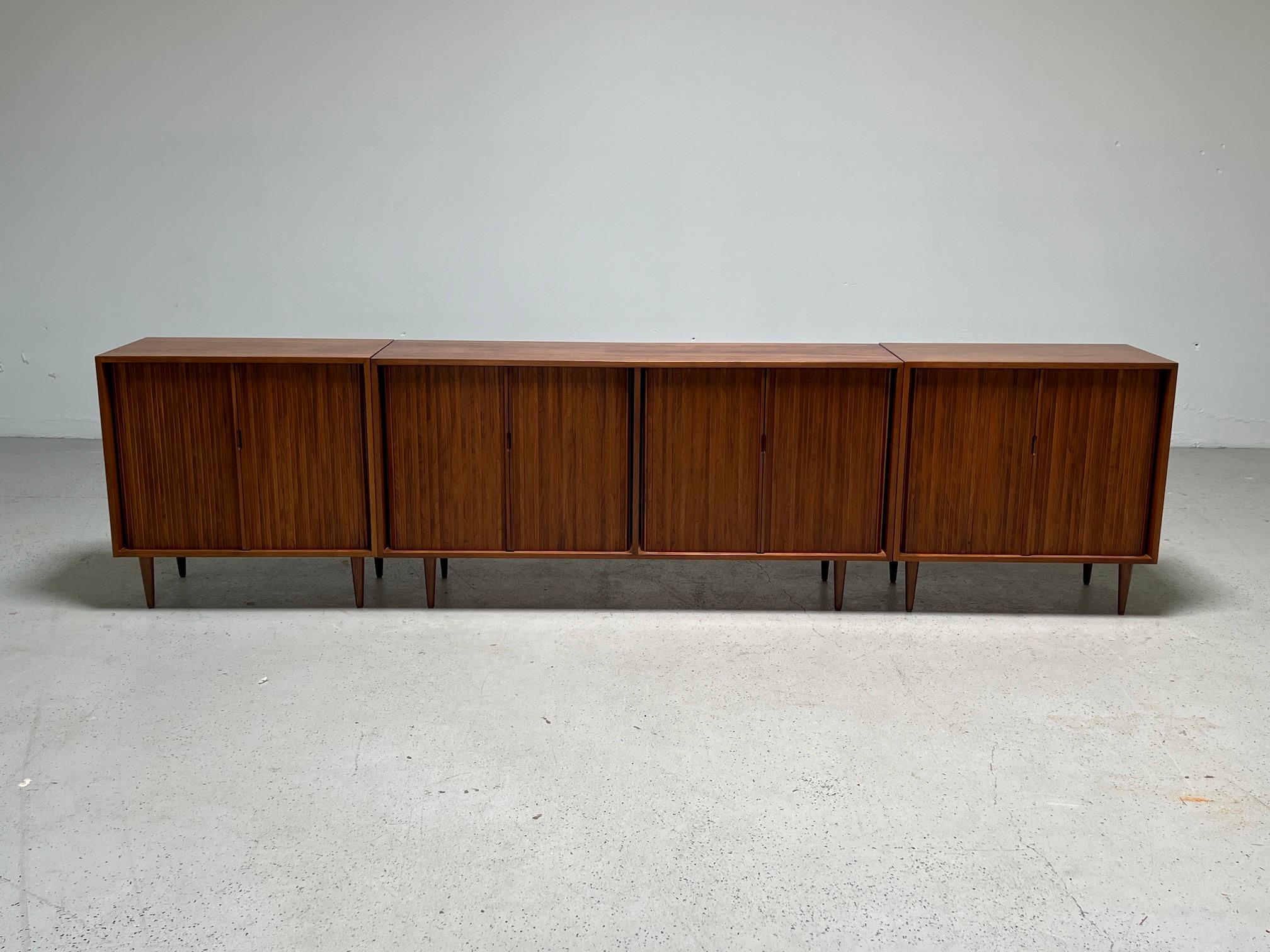 A set of three walnut cabinets by Milo Baughman for Glenn of California. Larger cabinet (64.75
