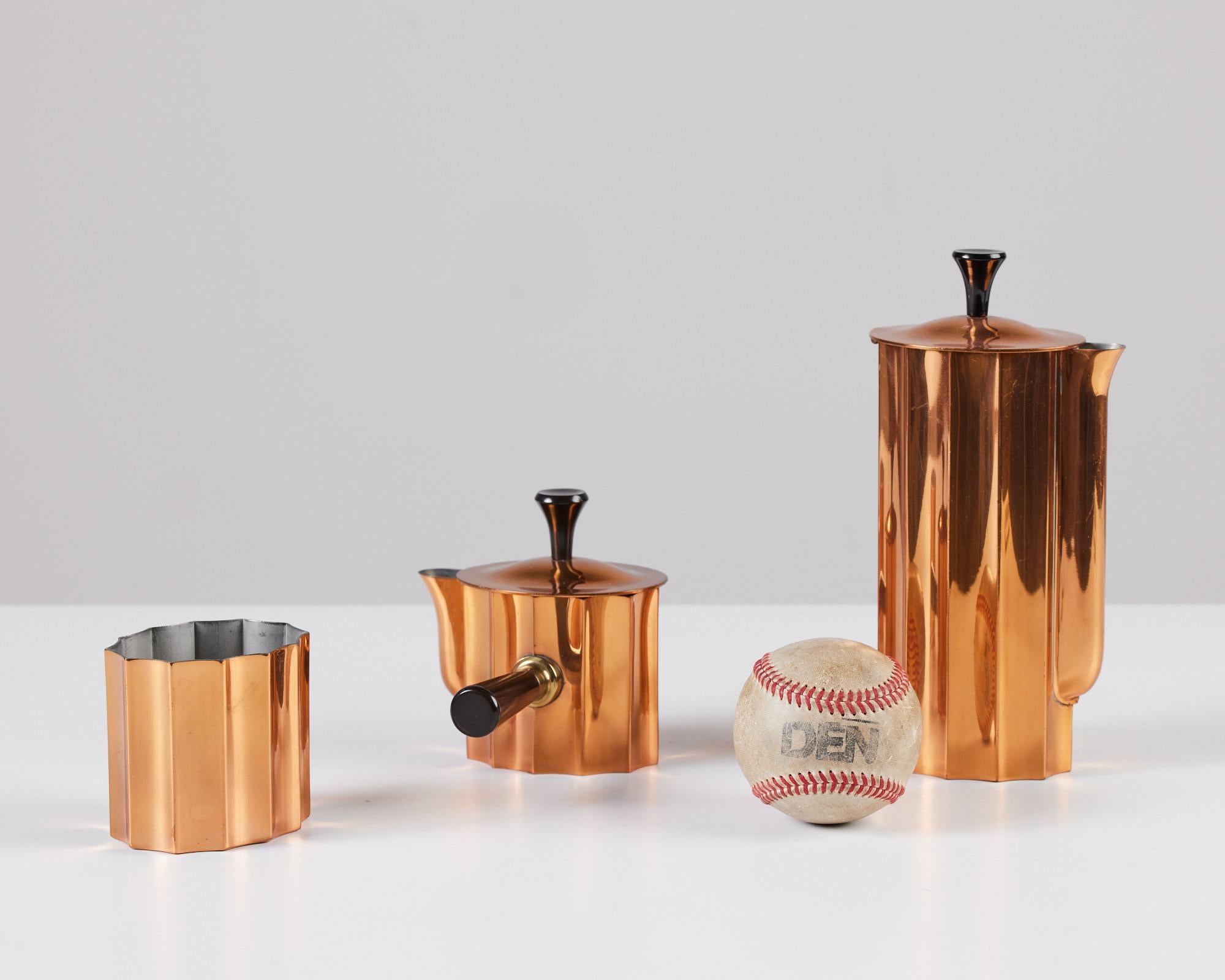 Three piece tea set by Walter von Nessen for Chase, USA, c.1930s. The set includes a tea pot, creamer and sugar bowl with Bakelite handles. The polished copper Art Deco set is impressed with [Chase USA] and feature the Chase Minotaur Archer logo on