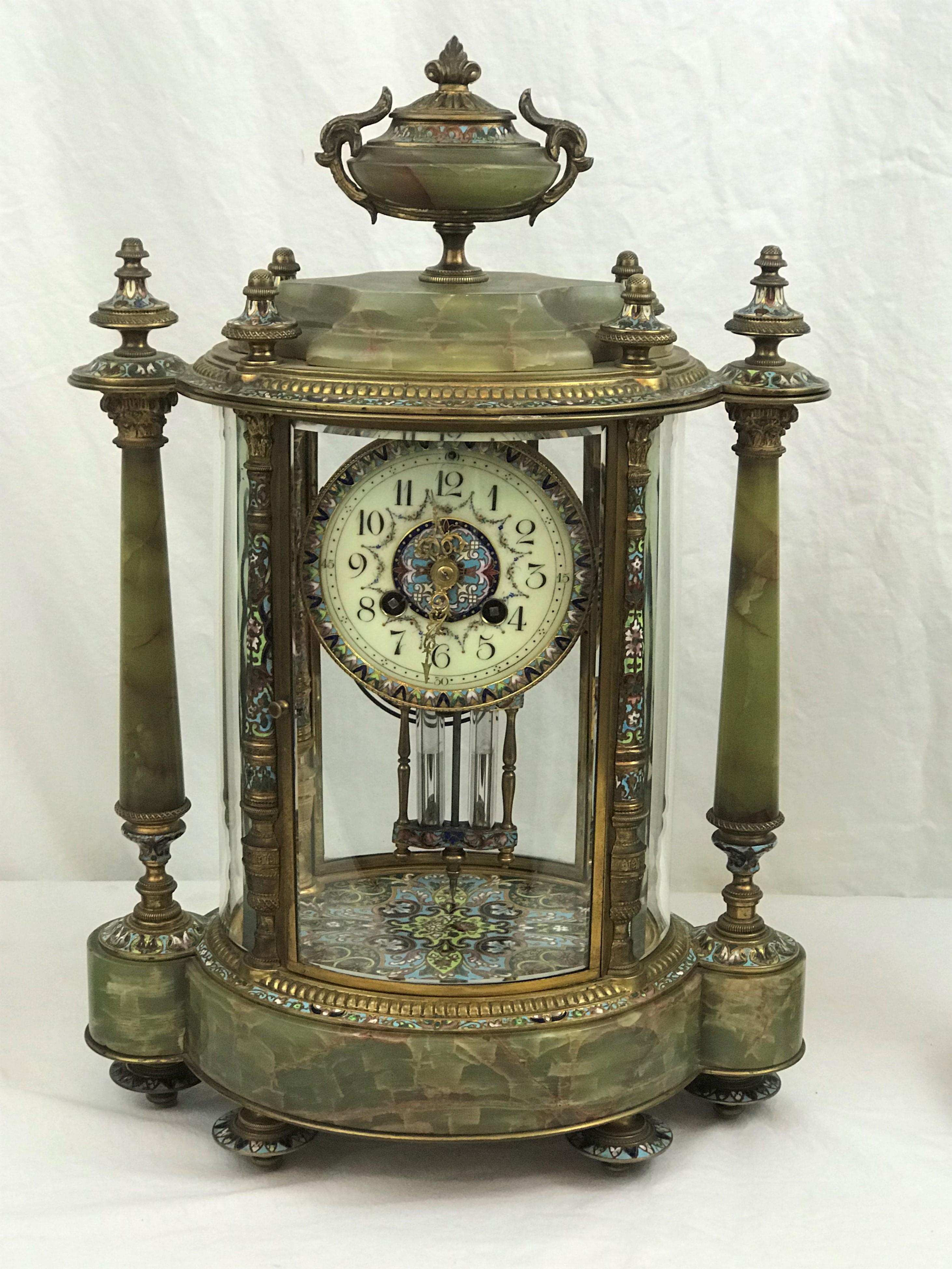 Tiffany & Co. Three piece garniture set. Crystal regulator clock with pair of side urns. Green onyx, cloisonne and ormolu, circa 1900. Excellent condition.

Clock with porcelain and cloisonne dial, cloisonne on pendulum and bottom interior.