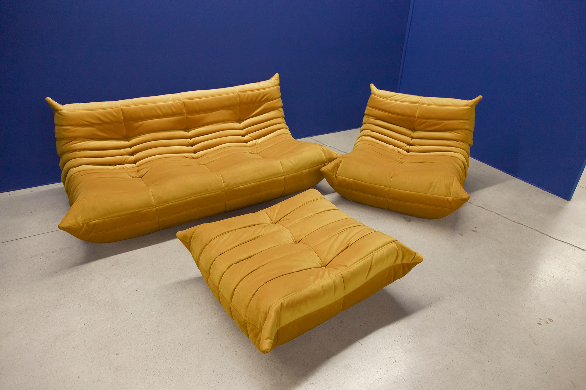 Three-piece Togo set, Design by Michel Ducaroy, manufactured by Ligne Roset this Togo living room set was designed by Michel Ducaroy in 1974 and was manufactured by Ligne Roset in France. It has been reupholstered in golden yellow high quality