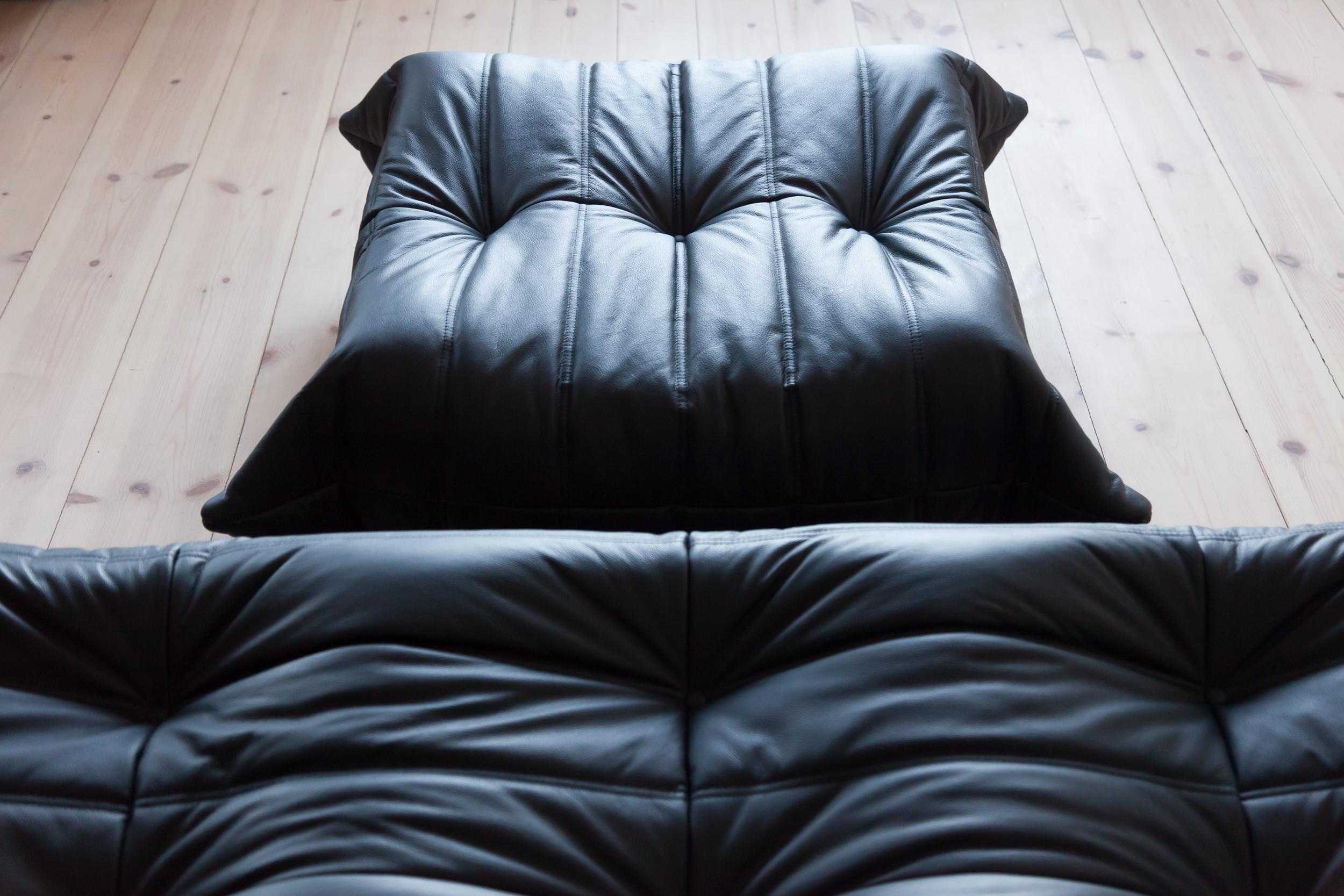 Three-piece togo set was designed by Michel Ducaroy in 1973 and was manufactured by Ligne Roset in France. It has been reupholstered in black high quality leather, and is made up of the following pieces, each with the original Ligne Roset logo and