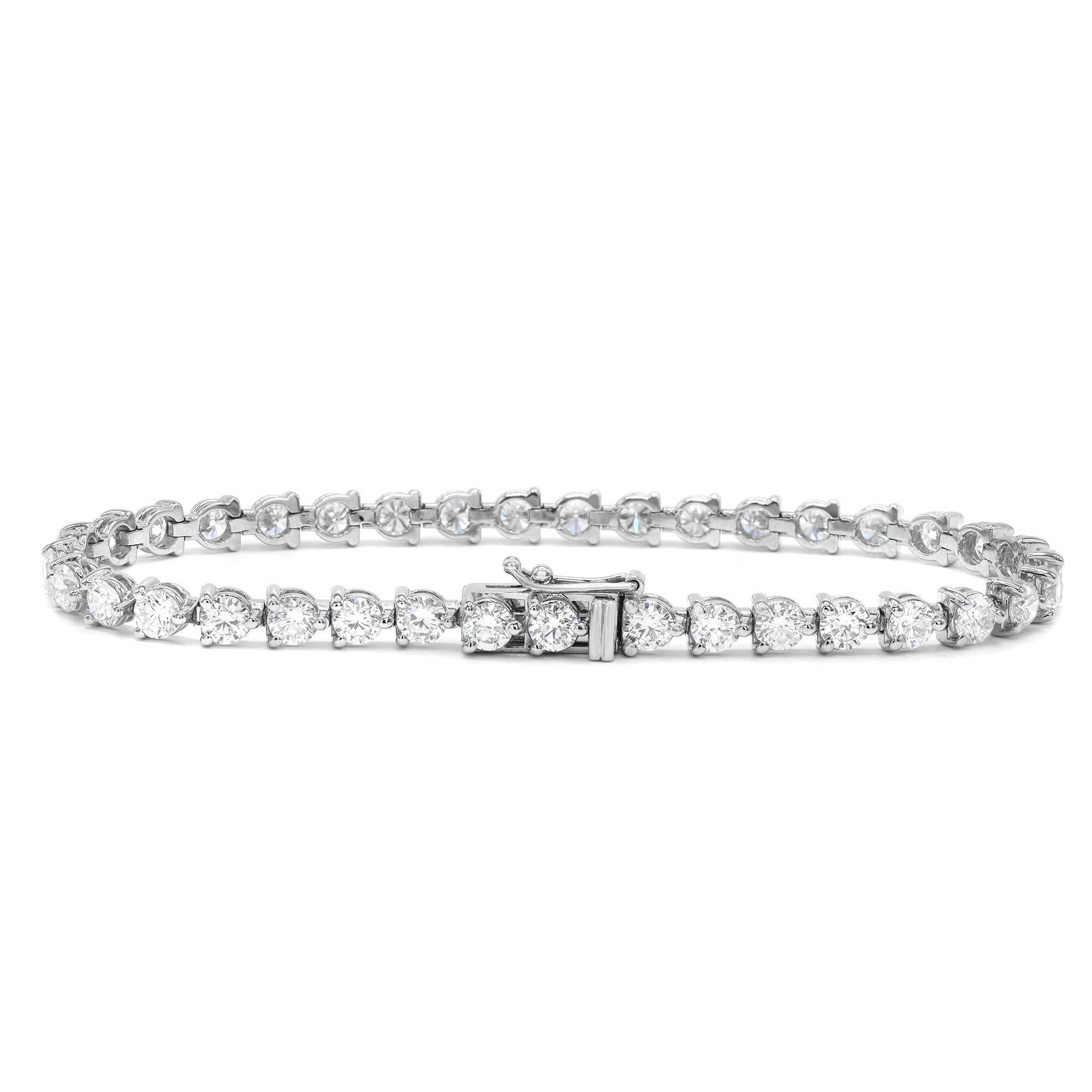 Classic yet elegant, this breathtaking tennis bracelet is crafted in 14K white gold with 37 prong set dazzling round cut diamonds. Three prong setting. The total diamond carat weight is 7.03 with each diamond size 3.7 mm. The bright white diamonds