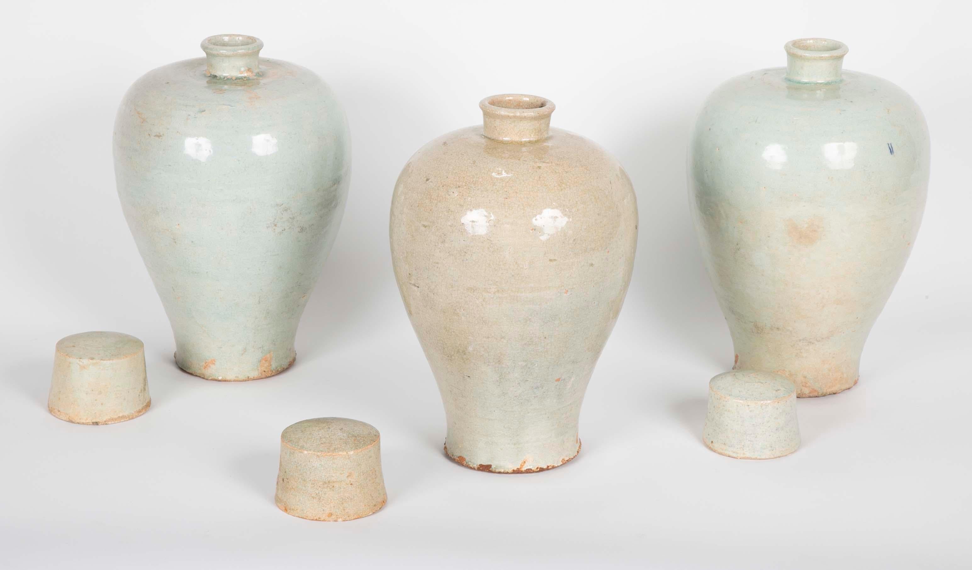 Three Qingbai glazed porcelain covered vases of ovoid form with pale blue glaze. Yuan Dynasty ( 1279 - 1368 ).